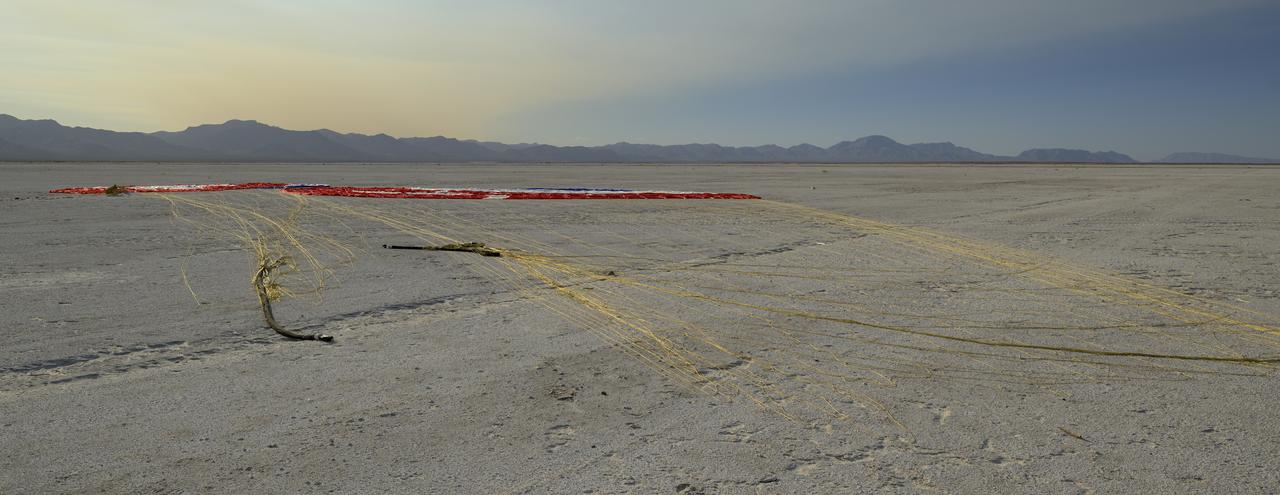 The Boeing CST-100 Starliner parachute is seen after the spacecraft landed at White Sands Missile Range’s Space Harbor, Wednesday, May 25, 2022, in New Mexico. Boeing’s Orbital Flight Test-2 (OFT-2) is Starliner’s second uncrewed flight test to the International Space Station as part of NASA's Commercial Crew Program. OFT-2 serves as an end-to-end test of the system's capabilities. Photo Credit: (NASA/Bill Ingalls)