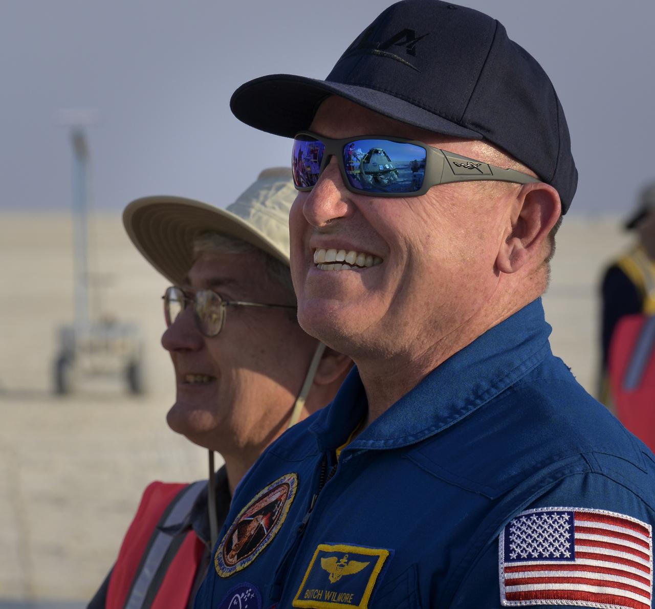 NASA astronaut Butch Wilmore watches as teams work around Boeing’s CST-100 Starliner spacecraft after it landed at White Sands Missile Range’s Space Harbor, Wednesday, May 25, 2022, in New Mexico. Boeing’s Orbital Flight Test-2 (OFT-2) is Starliner’s second uncrewed flight test to the International Space Station as part of NASA's Commercial Crew Program. OFT-2 serves as an end-to-end test of the system's capabilities. Photo Credit: (NASA/Bill Ingalls)