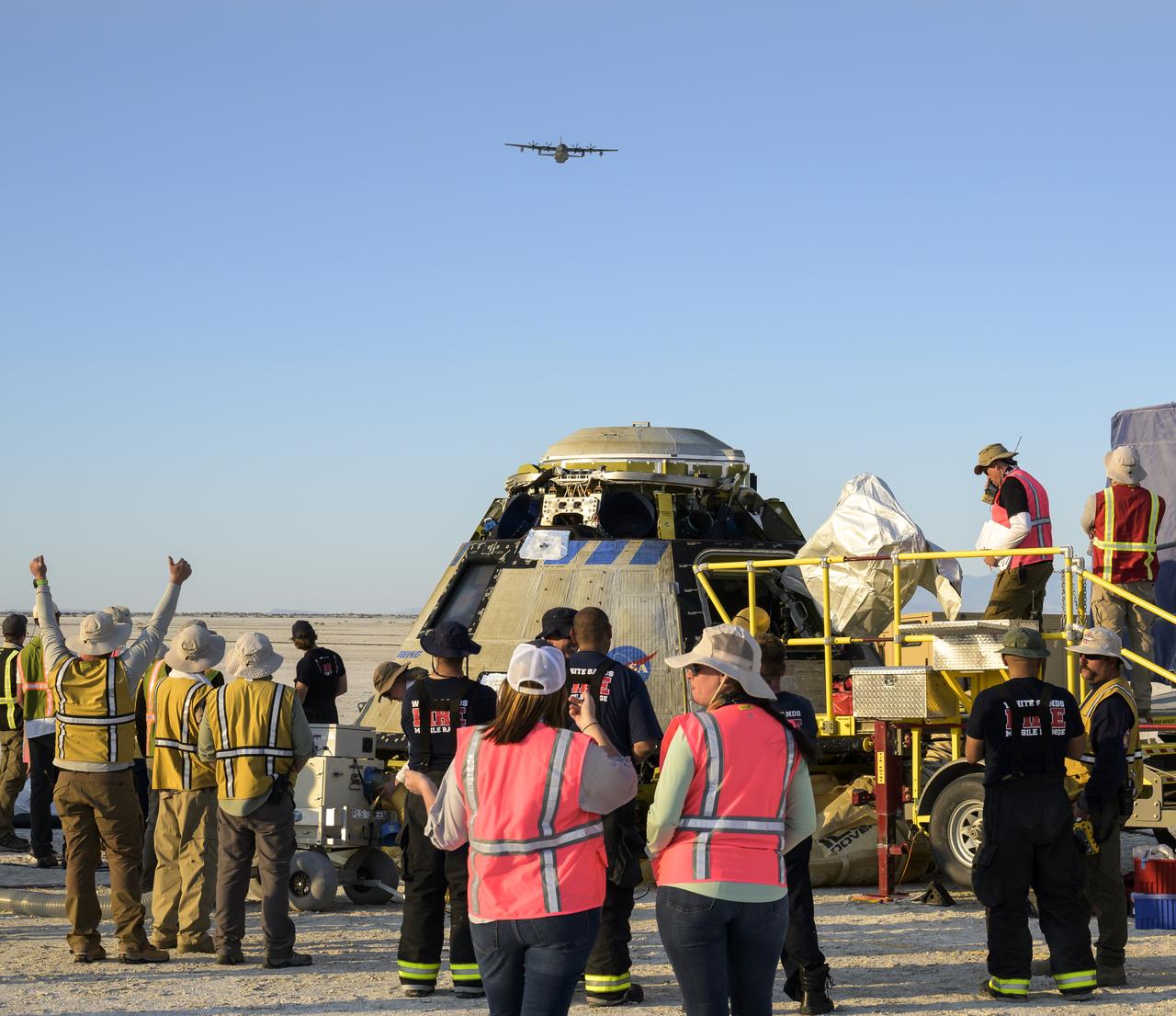A USAF HC-130J Hercules aircraft from the 79th rescue squadron flys over the Boeing CST-100 Starliner spacecraft as a Line of Sight (LOS) communications test is conducted between the two shortly after Starliner landed at White Sands Missile Range’s Space Harbor, Wednesday, May 25, 2022, in New Mexico. Boeing’s Orbital Flight Test-2 (OFT-2) is Starliner’s second uncrewed flight test to the International Space Station as part of NASA's Commercial Crew Program. OFT-2 serves as an end-to-end test of the system's capabilities. Photo Credit: (NASA/Bill Ingalls)