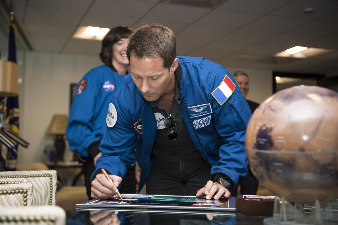 NASA’s SpaceX Crew-2 ESA (European Space Agency) astronaut Thomas Pesquet signs a montage for NASA Associate Administrator Bob Cabana, Monday, June 6, 2022, at the Mary W. Jackson NASA Headquarters Building in Washington DC. Photo Credit: (NASA/Aubrey Gemignani)