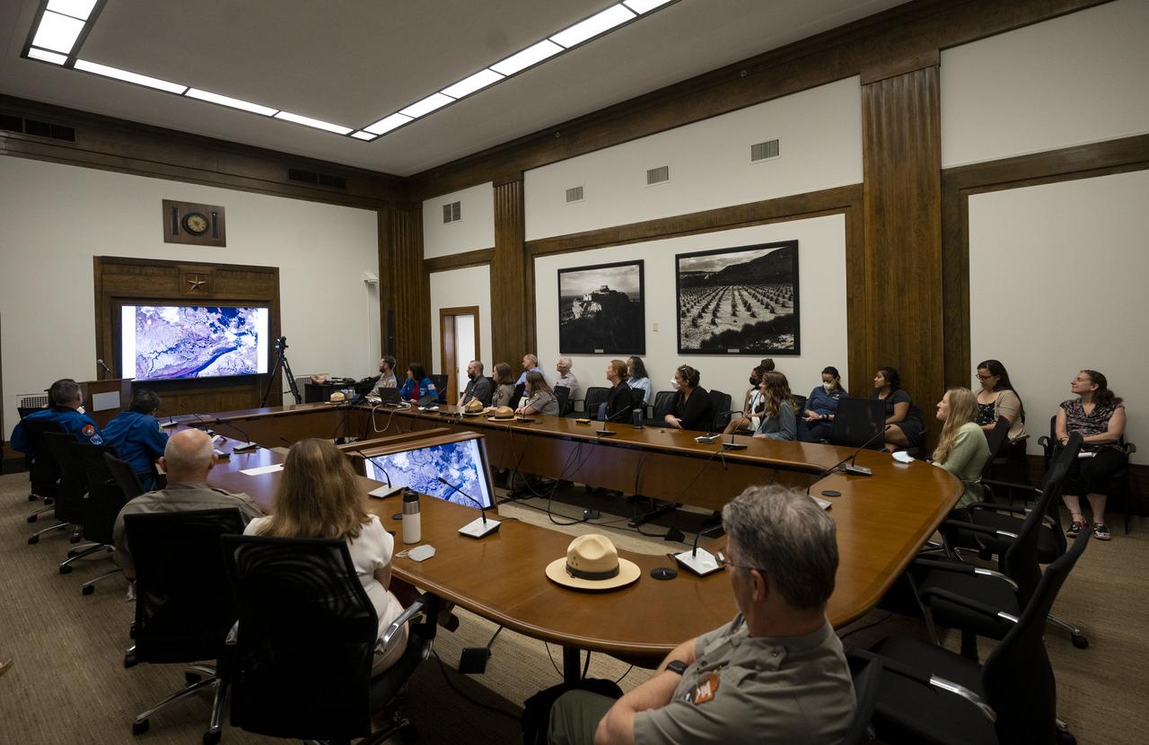 NASA astronaut Megan McArthur shows pictures of National Parks taken from the International Space Station during Expeditions 65 and 66 during a presentation to leadership and rangers who participate in the National Park Service’s astronomy and dark sky programs, Thursday, June 9, 2022 at the U.S. Department of the Interior in Washington, DC. McArthur, NASA astronaut Shane Kimbrough, Japan Aerospace Exploration Agency (JAXA) astronaut Akihiko Hoshide, and ESA (European Space Agency) astronaut Thomas Pesquet, flew on NASA’s SpaceX Crew-2 mission, the second crew rotation mission to the International Space Station as part of the agency’s Commercial Crew Program, and spent 198 days aboard the orbiting laboratory as part of Expeditions 65 and 66.  Photo Credit: (NASA/Joel Kowsky)