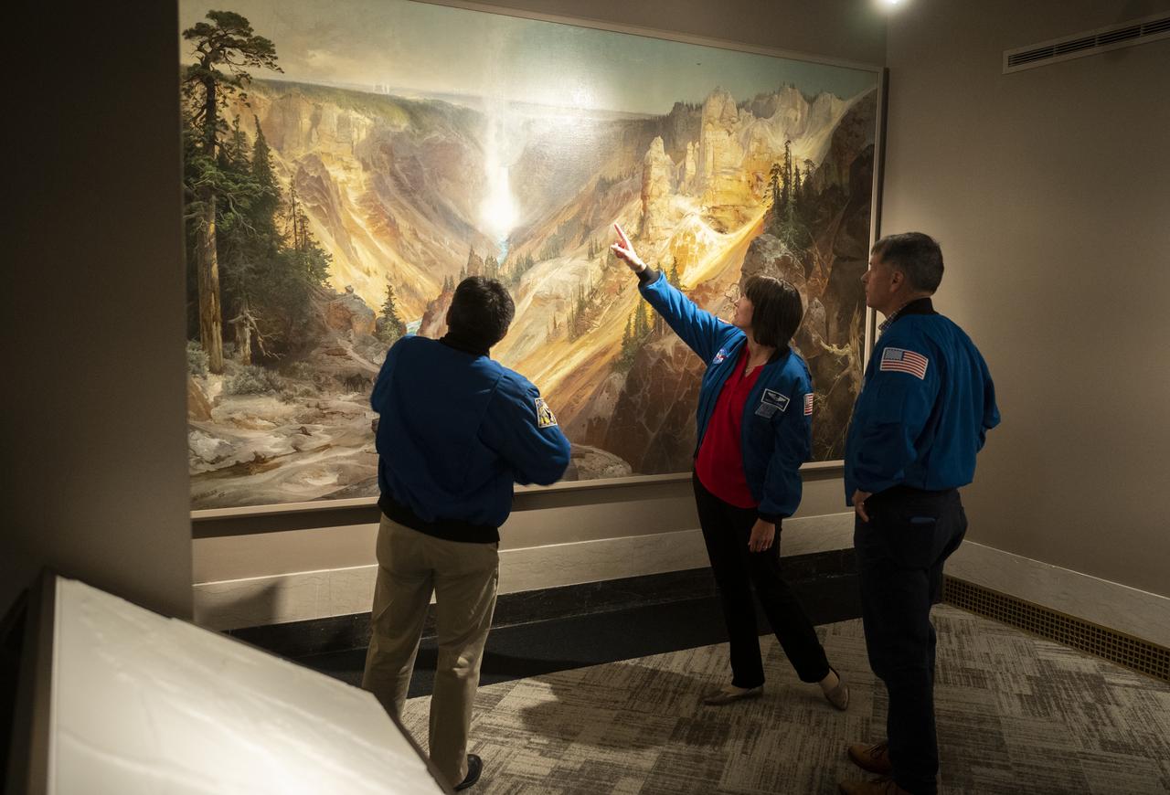 NASA’s SpaceX Crew-2 astronauts Akihiko Hoshide of the Japan Aerospace Exploration Agency (JAXA), left, and NASA astronauts Megan McArthur, center, and Shane Kimbrough, right, look at Thomas Moran’s 1872 painting “The Grand Canyon of Yellowstone,” Thursday, June 9, 2022, during a visit to the National Park Service at the U.S. Department of the Interior in Washington, DC. Kimbrough, McArthur, Hoshide, and ESA (European Space Agency) astronaut Thomas Pesquet completed the second crew rotation mission to the International Space Station as part of the agency’s Commercial Crew Program and spent 198 days aboard the orbiting laboratory as part of Expeditions 65 and 66.  Photo Credit: (NASA/Joel Kowsky)