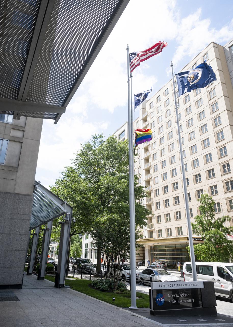 The Progress Pride flag is seen flying at the Mary W. Jackson NASA Headquarters Building, Thursday, June 9, 2022, in Washington, DC. In recognition of LGBTQ+ Pride Month, the Progress Pride flag will be flown outside of the agency’s headquarters for the month of June. Photo Credit: (NASA/Joel Kowsky)