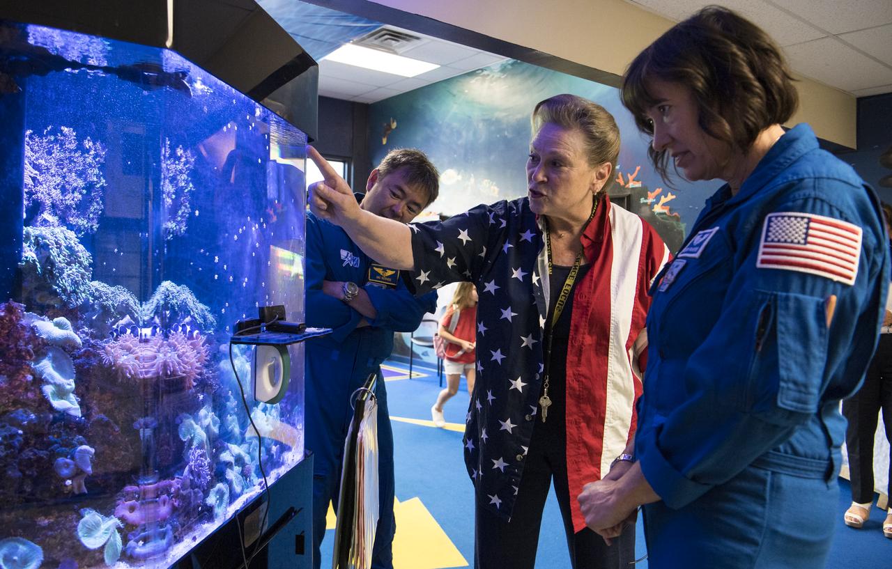 Principle of Arlington Science Focus Elementary School, Mary Begley, shows NASA’s SpaceX Crew-2 NASA astronauts Megan McArthur, right, and Japan Aerospace Exploration Agency (JAXA) astronaut Akihiko Hoshide, left, the school's aquarium, during a visit to Arlington Science Focus Elementary School, Friday, June 10, 2022, in Arlington, Virginia. Photo Credit: (NASA/Aubrey Gemignani)