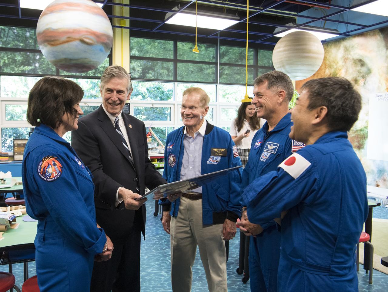 NASA’s SpaceX Crew-2 NASA astronauts Megan McArthur, left, and Shane Kimbrough, second from right, and Japan Aerospace Exploration Agency (JAXA) astronaut Akihiko Hoshide, right, present U.S. Rep. Don Beyer, D-Va., second from left, with a montage from their mission, while NASA Administrator Bill Nelson looks on, during a visit to Arlington Science Focus Elementary School, Friday, June 10, 2022, in Arlington, Virginia. Photo Credit: (NASA/Aubrey Gemignani)