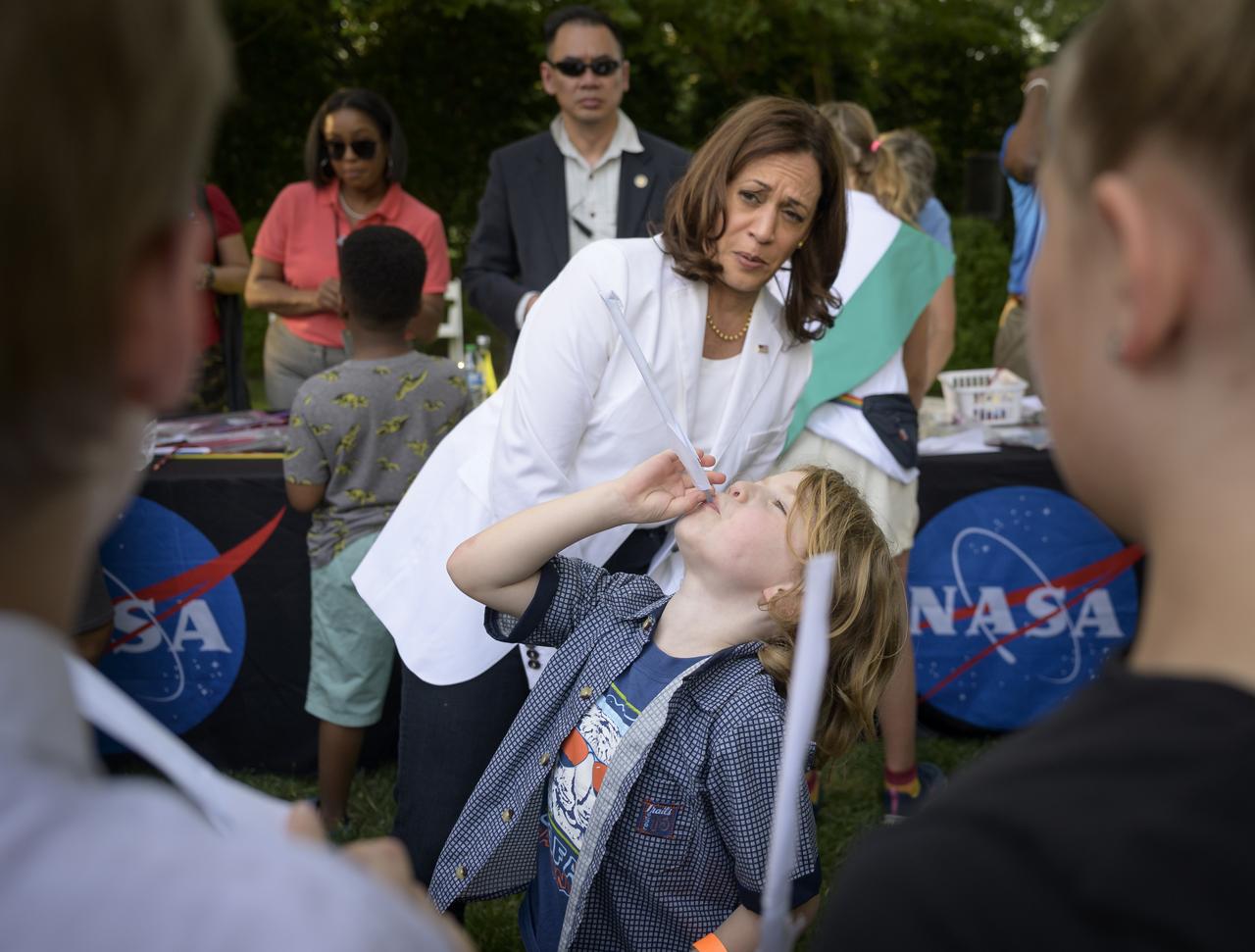 Vice President Kamala Harris interacts with children during hands-on STEM activities on the grounds of the Vice President's residence at the Naval Observatory, Friday, June 17, 2022, in Washington. The Vice President and Second Gentleman hosted an evening of NASA STEM activities at the Naval Observatory for military families and local STEM students and their families, including a special screening of Disney Pixar’s Lightyear. Photo Credit: (NASA/Bill Ingalls)