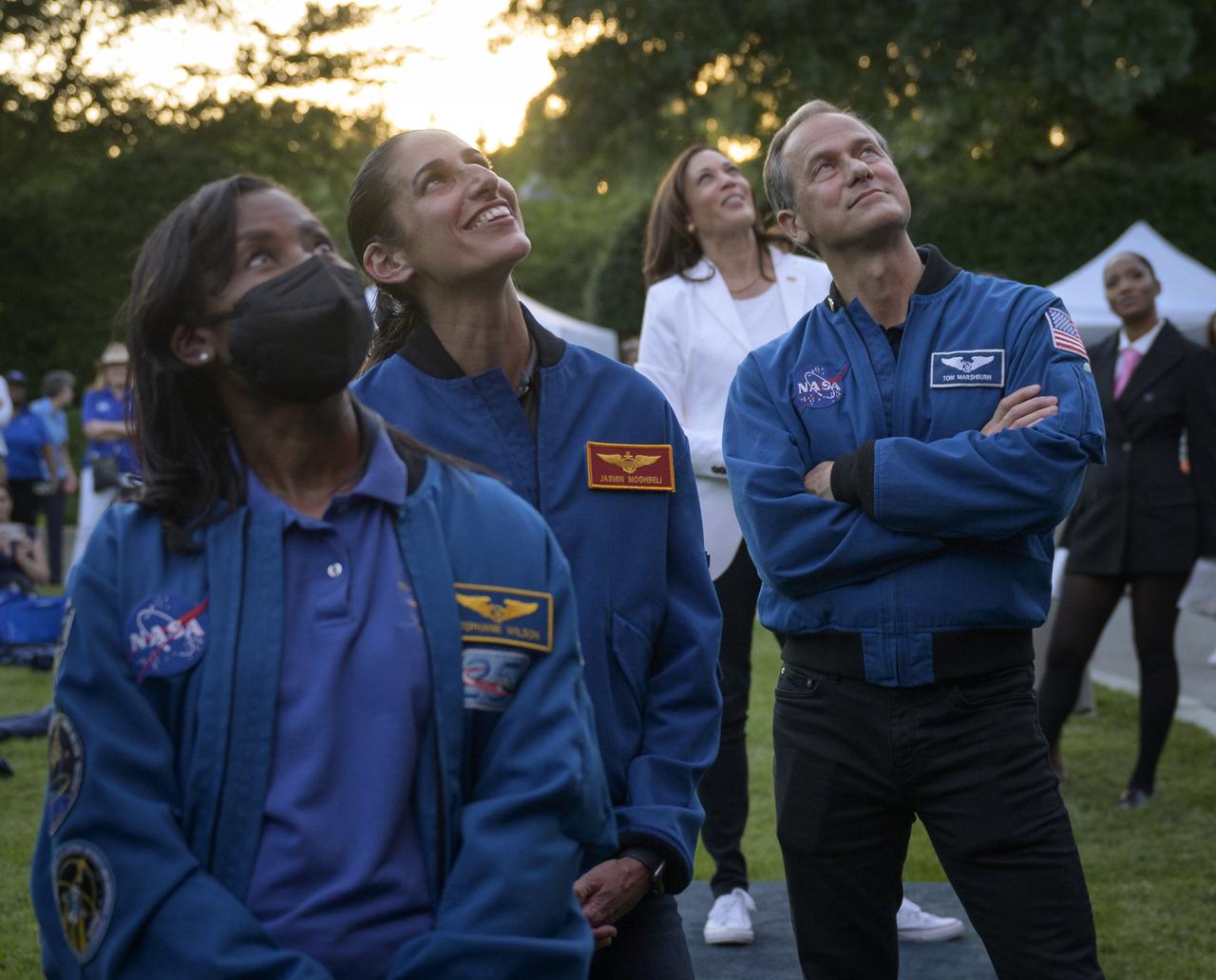 NASA astronauts Stephanie Wilson, left, Jasmin Moghbeli, and Tom Marshburn, along with Vice President Kamala Harris watch a video screen as NASA astronauts onboard the International Space Station give remarks prior to the screening of the movie Lightyear on the grounds of the Vice President's residence at the Naval Observatory, Friday, June 17, 2022, in Washington. The Vice President and Second Gentleman hosted an evening of NASA STEM activities at the Naval Observatory for military families and local STEM students and their families, including a special screening of Disney Pixar’s Lightyear. Photo Credit: (NASA/Bill Ingalls)