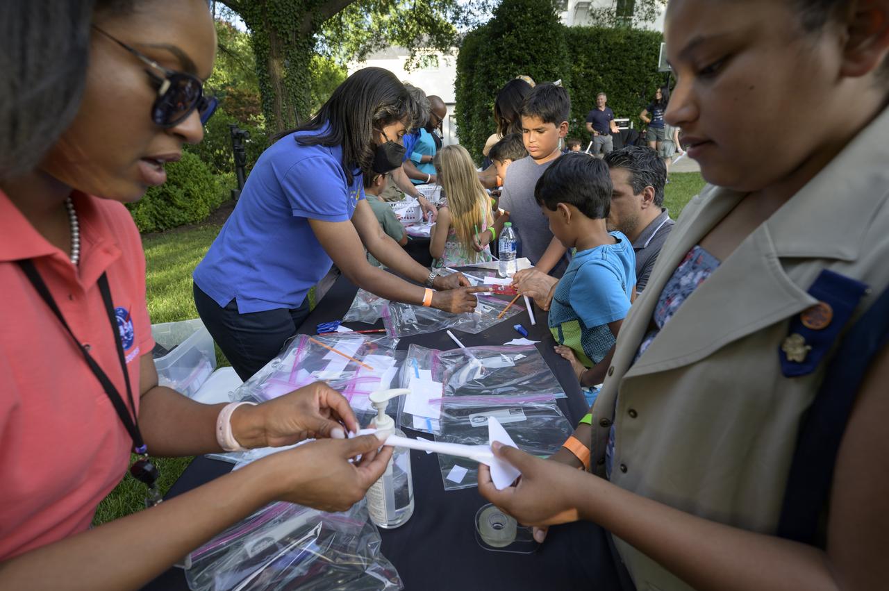 NASA astronaut Stephanie Wilson, 2nd from left, works with students during a hands-on STEM activity on the grounds of the Vice President's residence at the Naval Observatory, Friday, June 17, 2022, in Washington. The Vice President and Second Gentleman hosted an evening of NASA STEM activities at the Naval Observatory for military families and local STEM students and their families, including a special screening of Disney Pixar’s Lightyear. Photo Credit: (NASA/Bill Ingalls)