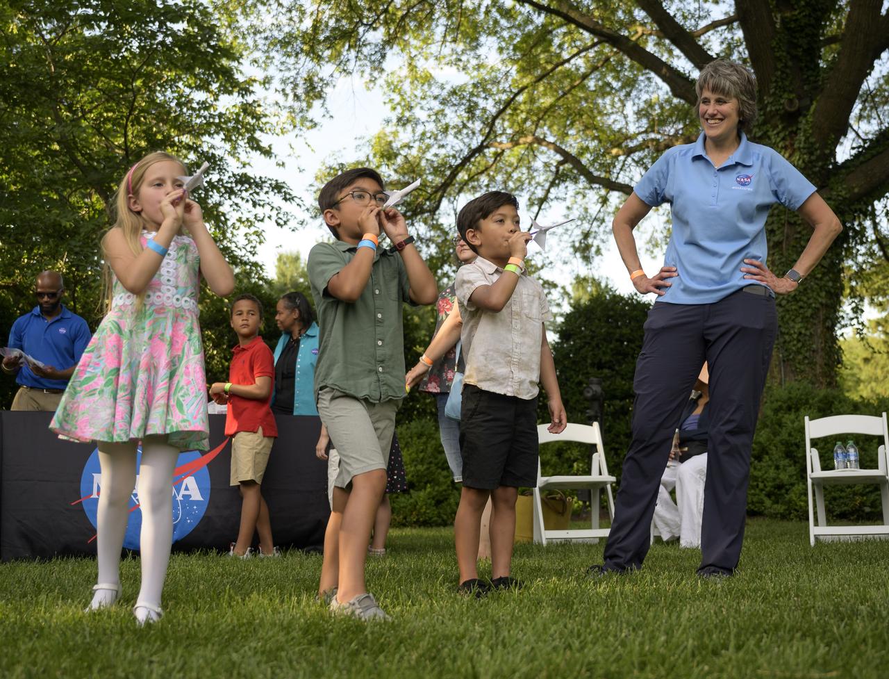 Cindy Hasselbring, NASA K-12 Education Advisor at NASA’s Office of STEM Engagement, works hands-on STEM activities with students from 4th-8th grade on the grounds of the Vice President's residence at the Naval Observatory, Friday, June 17, 2022, in Washington. The Vice President and Second Gentleman hosted an evening of NASA STEM activities at the Naval Observatory for military families and local STEM students and their families, including a special screening of Disney Pixar’s Lightyear. Photo Credit: (NASA/Bill Ingalls)