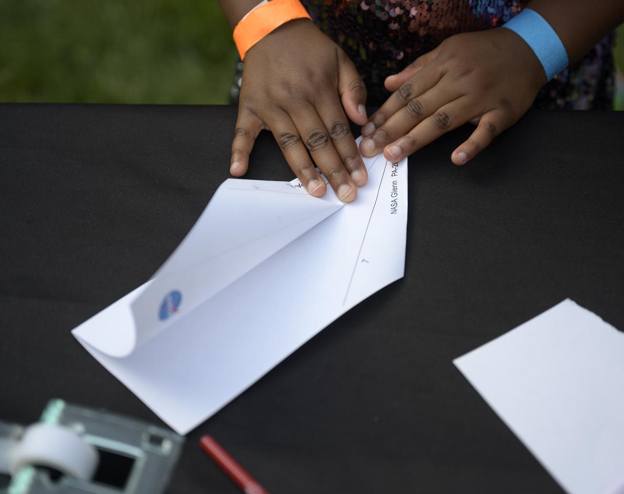 Students work an airplane building hands-on STEM activity on the grounds of the Vice President's residence at the Naval Observatory, Friday, June 17, 2022, in Washington. The Vice President and Second Gentleman hosted an evening of NASA STEM activities at the Naval Observatory for military families and local STEM students and their families, including a special screening of Disney Pixar’s Lightyear. Photo Credit: (NASA/Bill Ingalls)