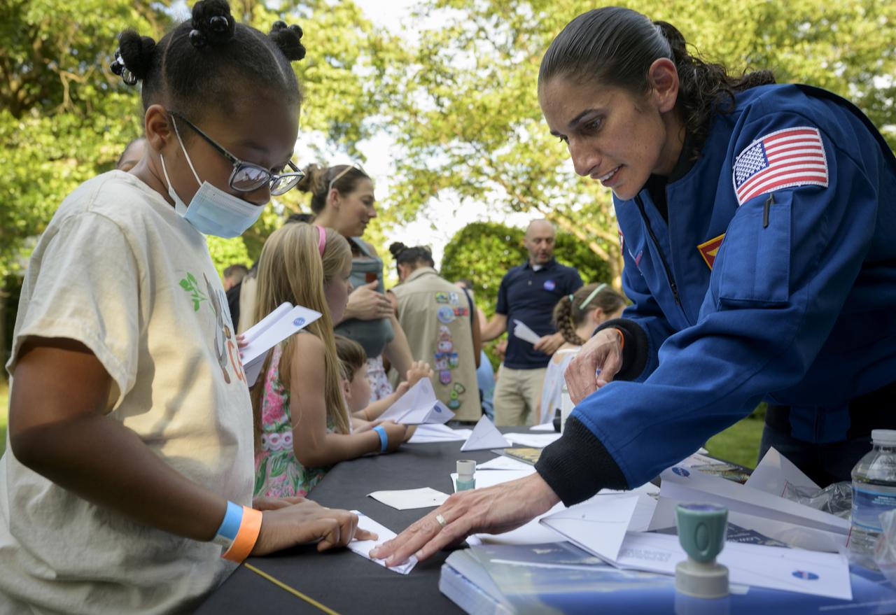 NASA astronaut Jasmin Moghbeli works with students during a hands-on STEM activity on the grounds of the Vice President's residence at the Naval Observatory, Friday, June 17, 2022, in Washington. The Vice President and Second Gentleman hosted an evening of NASA STEM activities at the Naval Observatory for military families and local STEM students and their families, including a special screening of Disney Pixar’s Lightyear. Photo Credit: (NASA/Bill Ingalls)