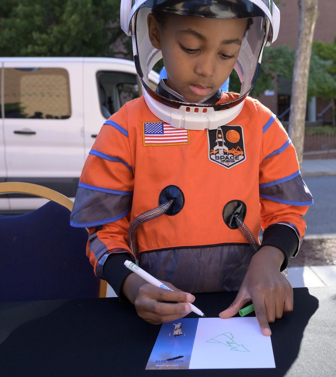 6-year old Armani Bonds draws on a postcard that will be sent to space by Club for the Future on a Blue Origin New Shepard rocket prior to he and his family screening the NASA produced documentary “The Color of Space” at Howard University’s Cramton Auditorium in Washington, Saturday, June 18, 2022. Premiering on Juneteenth, the federal holiday commemorating the end of slavery in the United States, “The Color of Space” is an inspirational documentary that tells the stories of NASA’s Black astronauts determined to reach the stars. Photo Credit: (NASA/Bill Ingalls)