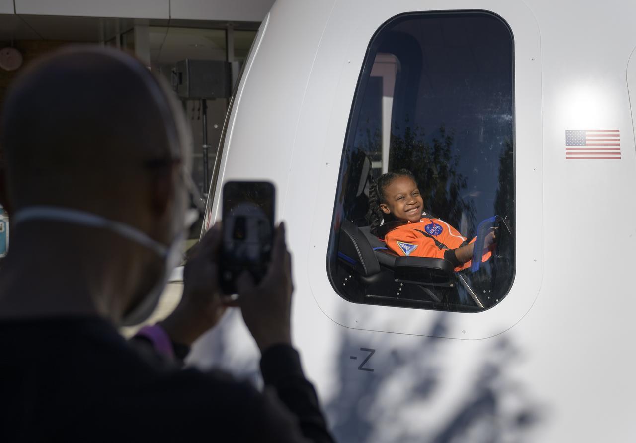 9-year old Amara Bowman smiles as her father photographs her inside a Blue Origin New Shepard capsule mockup prior to the screening of the NASA produced documentary “The Color of Space” at Howard University’s Cramton Auditorium in Washington, Saturday, June 18, 2022. Premiering on Juneteenth, the federal holiday commemorating the end of slavery in the United States, “The Color of Space” is an inspirational documentary that tells the stories of NASA’s Black astronauts determined to reach the stars. Photo Credit: (NASA/Bill Ingalls)