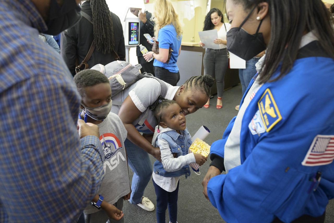 NASA astronaut Stephanie Wilson talks with 7-year old Tre Rahaman, left, and 4-year old Amira Rahaman, along with their mother Nadia Rahaman of Silver Sping, Maryland prior to the screening of the NASA produced documentary “The Color of Space” at Howard University’s Cramton Auditorium in Washington, Saturday, June 18, 2022. Premiering on Juneteenth, the federal holiday commemorating the end of slavery in the United States, “The Color of Space” is an inspirational documentary that tells the stories of NASA’s Black astronauts determined to reach the stars. Photo Credit: (NASA/Bill Ingalls)