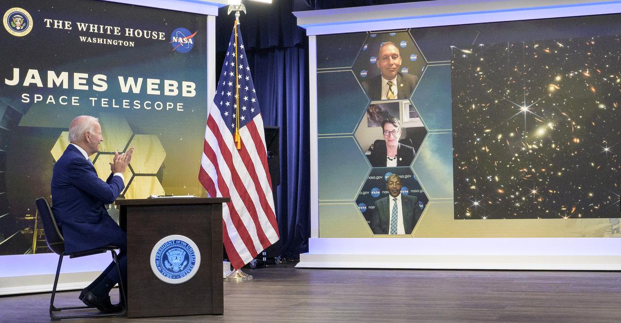 U.S. President Joe Biden previews the first full-color image from NASA’s James Webb Space Telescope, the highest-resolution image of the infrared universe in history, Monday, July 11, 2022, in the South Court Auditorium in the Eisenhower Executive Office Building on the White House complex in Washington. On screen are NASA Associate Administrator for the Science Mission Directorate Thomas Zurbuchen, top, Deputy Director of the Space Telescope Science Institute (STScI) Nancy Levenson, and NASA James Webb Space Telescope Program Director Greg Robinson, bottom. Photo Credit: (NASA/Bill Ingalls)