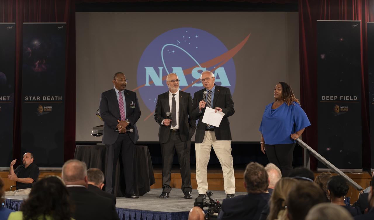 NASA Program Director for the James Webb Space Telescope Program Greg Robinson, left, Vice President and Program Manager, Webb, Northrop Grumman, Scott Willoughby, center, and Michelle Jones, Chief of the Office of Communications at NASA's Goddard Space Flight Center, right, look on as NASA James Webb Space Telescope Project Manager Bill Ochs, second from right, delivers remarks ahead of the release of the first images from NASA’s James Webb Space Telescope, Tuesday, July 12, 2022, at NASA’s Goddard Space Flight Center in Greenbelt, Md.  The first full-color images and spectroscopic data from the James Webb Space Telescope, a partnership with ESA (European Space Agency) and the Canadian Space Agency (CSA), are a demonstration of the power of Webb as the telescope begins its science mission to unfold the infrared universe. Photo Credit: (NASA/Taylor Mickal)