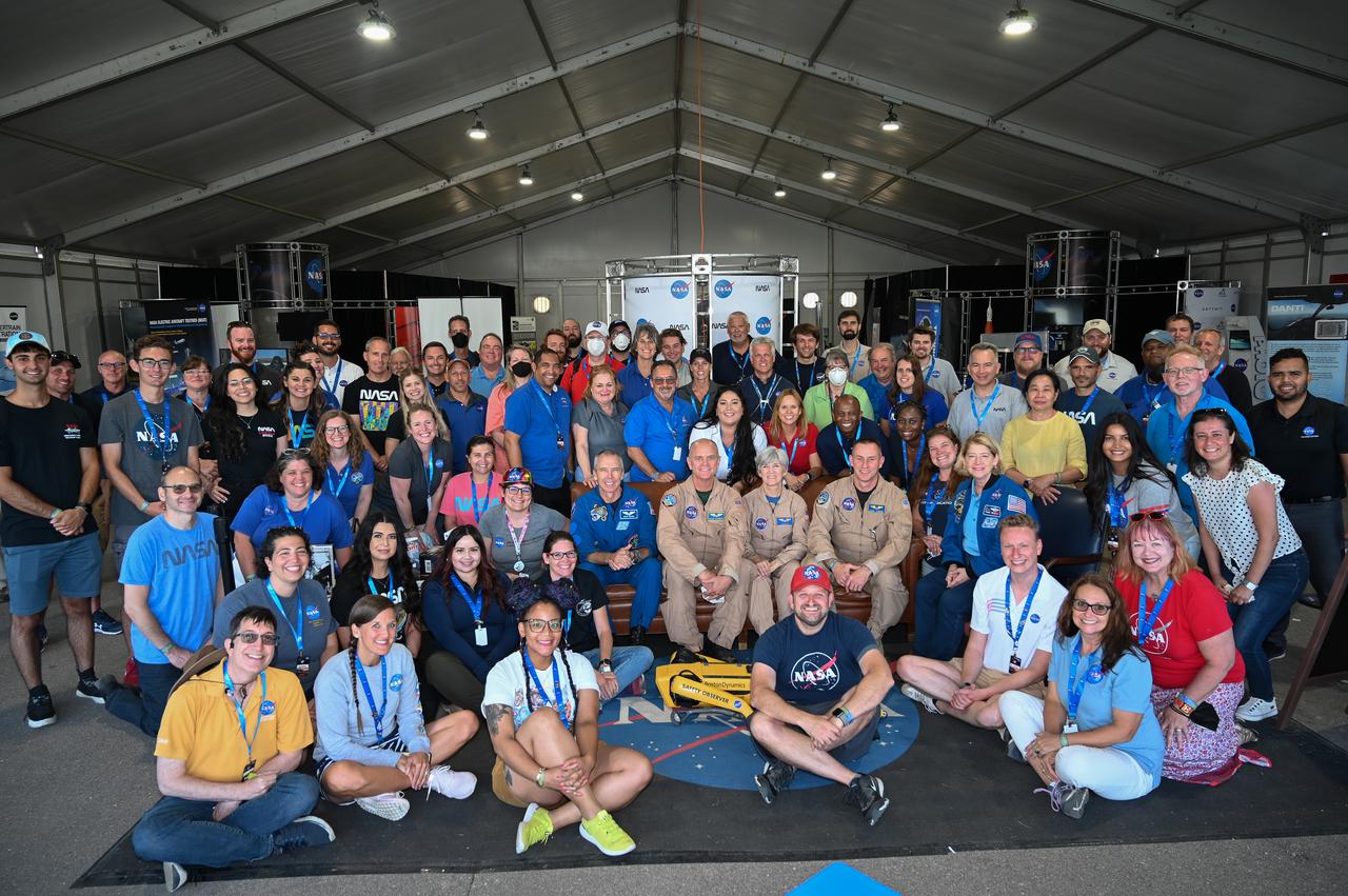 NASA pavilion staff pose for a group picture on Thursday, July 28, 2022, at the EAA AirVenture. They were joined by Deputy Administrator Pam Melroy.