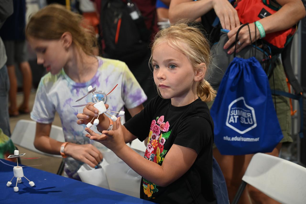 Adelaide Falzon assembles her version of the Mars Ingenuity helicopter on Wednesday, July 27, 2022, in NASA's STEM Zone at AirVenture Oshkosh.