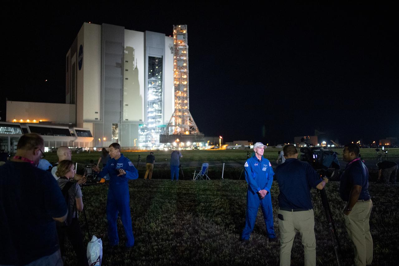 NASA astronauts Don Pettit, left, and Stan Love, right, speak with members of the media as NASA’s Space Launch System (SLS) rocket with the Orion spacecraft aboard is seen atop the mobile launcher is rolled out of the Vehicle Assembly Building to Launch Pad 39B, Tuesday, Aug. 16, 2022, at NASA’s Kennedy Space Center in Florida. NASA’s Artemis I mission is the first integrated test of the agency’s deep space exploration systems: the Orion spacecraft, SLS rocket, and supporting ground systems. Launch of the uncrewed flight test is targeted for no earlier than Aug. 29. Photo Credit: (NASA/Joel Kowsky)
