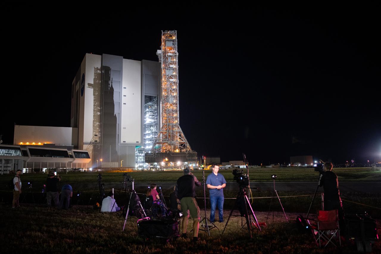 Members of the media are seen as NASA’s Space Launch System (SLS) rocket with the Orion spacecraft aboard is rolled out of the Vehicle Assembly Building, Tuesday, Aug. 16, 2022, at NASA’s Kennedy Space Center in Florida. NASA’s Artemis I flight test is the first integrated test of the agency’s deep space exploration systems: the Orion spacecraft, SLS rocket, and supporting ground systems. Launch of the uncrewed flight test is targeted for no earlier than Aug. 29. Photo Credit: (NASA/Joel Kowsky)