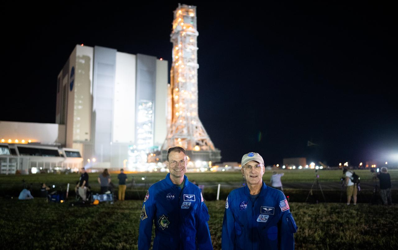 NASA astronauts Stan Love, left, and Don Pettit, right pose for a picture as NASA’s Space Launch System (SLS) rocket with the Orion spacecraft aboard atop the mobile launcher is rolled out of the Vehicle Assembly Building to Launch Pad 39B, Tuesday, Aug. 16, 2022, at NASA’s Kennedy Space Center in Florida. NASA’s Artemis I mission is the first integrated test of the agency’s deep space exploration systems: the Orion spacecraft, SLS rocket, and supporting ground systems. Launch of the uncrewed flight test is targeted for no earlier than Aug. 29. Photo Credit: (NASA/Joel Kowsky)