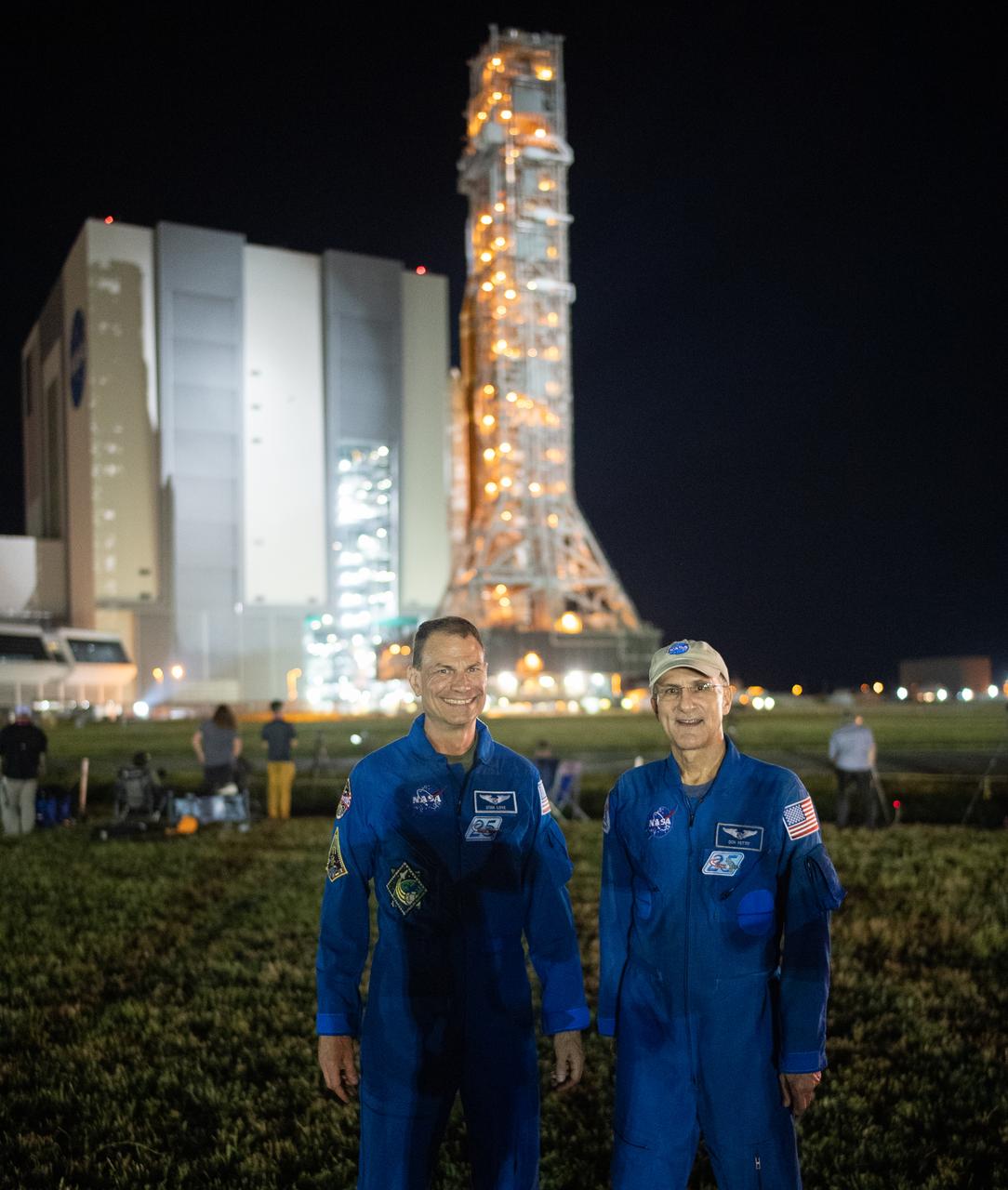 NASA astronauts Stan Love, left, and Don Pettit, right pose for a picture as NASA’s Space Launch System (SLS) rocket with the Orion spacecraft aboard atop the mobile launcher is rolled out of the Vehicle Assembly Building to Launch Pad 39B, Tuesday, Aug. 16, 2022, at NASA’s Kennedy Space Center in Florida. NASA’s Artemis I mission is the first integrated test of the agency’s deep space exploration systems: the Orion spacecraft, SLS rocket, and supporting ground systems. Launch of the uncrewed flight test is targeted for no earlier than Aug. 29. Photo Credit: (NASA/Joel Kowsky)