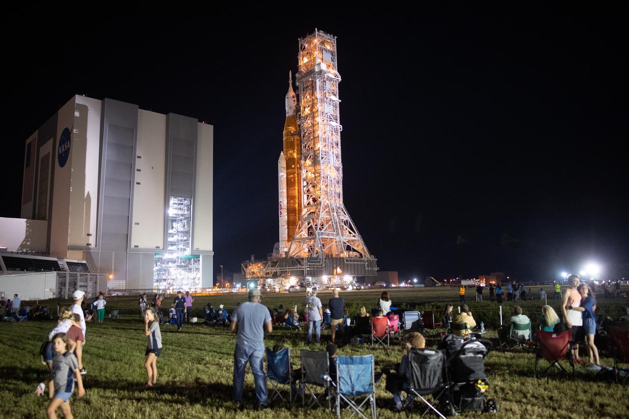 Invited guests and NASA employees watch as NASA’s Space Launch System (SLS) rocket with the Orion spacecraft aboard is rolled out of the Vehicle Assembly Building to Launch Pad 39B, Tuesday, Aug. 16, 2022, at NASA’s Kennedy Space Center in Florida. NASA’s Artemis I flight test is the first integrated test of the agency’s deep space exploration systems: the Orion spacecraft, SLS rocket, and supporting ground systems. Launch of the uncrewed flight test is targeted for no earlier than Aug. 29. Photo Credit: (NASA/Joel Kowsky)