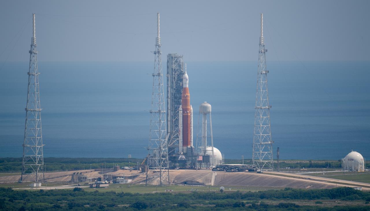 NASA’s Space Launch System (SLS) rocket with the Orion spacecraft aboard is seen atop a mobile launcher at Launch Pad 39B, Wednesday, Aug. 17, 2022, after making the four-mile journey to the launch pad at NASA’s Kennedy Space Center in Florida. NASA’s Artemis I mission is the first integrated test of the agency’s deep space exploration systems: the Orion spacecraft, SLS rocket, and supporting ground systems. Launch of the uncrewed flight test is targeted for no earlier than Aug. 29. Photo Credit: (NASA/Joel Kowsky)