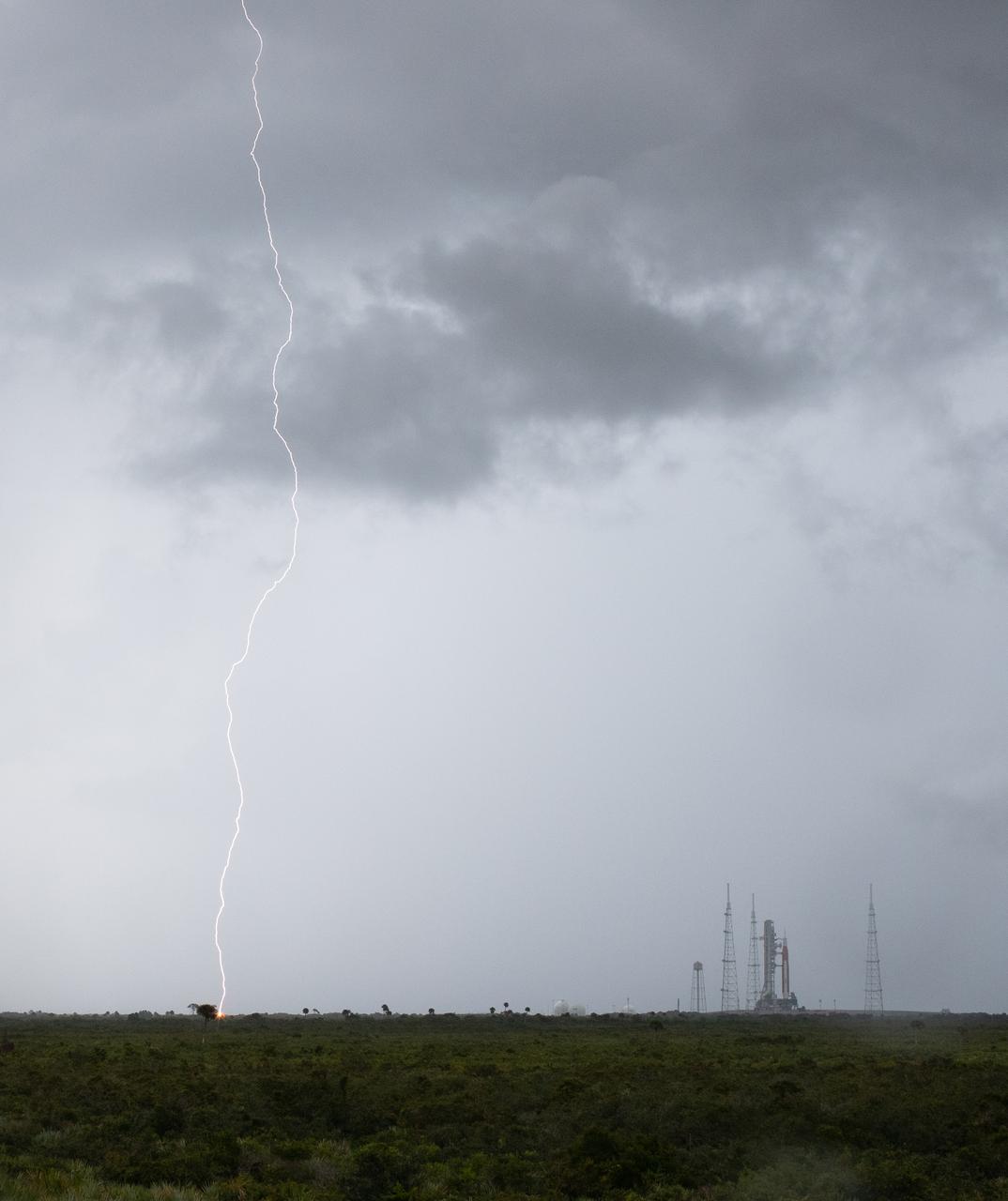 Lightning is seen near Launch Pad 39B as weather moves through the area as preparations for launch of NASA’s Space Launch System rocket and Orion spacecraft continue, Saturday, Aug. 27, 2022, at NASA’s Kennedy Space Center in Florida. NASA’s Artemis I flight test is the first integrated test of the agency’s deep space exploration systems: the Orion spacecraft, SLS rocket, and supporting ground systems. Launch of the uncrewed flight test is targeted for no earlier than Aug. 29 at 8:33 a.m. ET. Photo Credit: (NASA/Joel Kowsky)