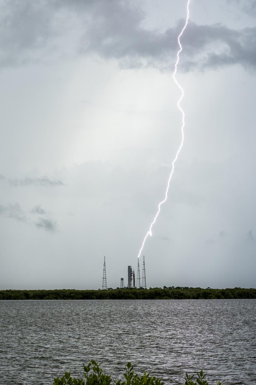 Lightning strikes the Launch Pad 39B protection system as preparations for launch of NASA’s Space Launch System (SLS) rocket with the Orion spacecraft aboard continue, Saturday, Aug. 27, 2022, at NASA’s Kennedy Space Center in Florida. NASA’s Artemis I flight test is the first integrated test of the agency’s deep space exploration systems: the Orion spacecraft, SLS rocket, and supporting ground systems. Launch of the uncrewed flight test is targeted for no earlier than Aug. 29 at 8:33 a.m. ET.  Photo Credit: (NASA/Keegan Barber)
