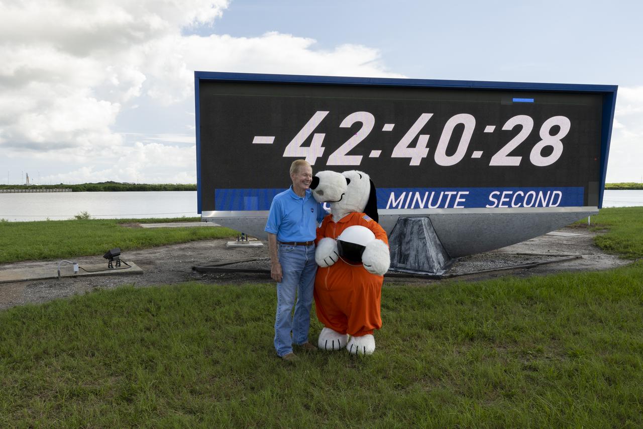NASA Administrator Bill Nelson poses for a picture with Snoopy at the Press Site countdown clock, Saturday, Aug. 27, 2022, at NASA’s Kennedy Space Center in Florida. NASA’s Artemis I flight test is the first integrated flight test of the agency’s deep space exploration systems: the Orion spacecraft, Space Launch System (SLS) rocket, and ground systems. Launch of the uncrewed flight test is targeted for no earlier than Aug. 29 at 8:33 a.m. ET. Photo Credit: (NASA/Keegan Barber)