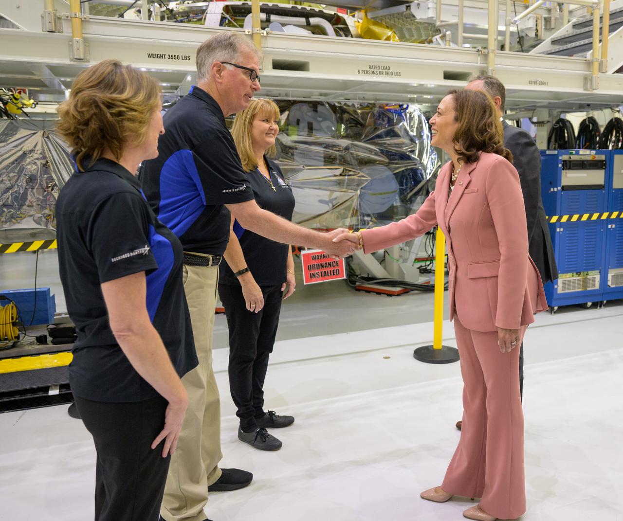 Vice President Kamala Harris is shakes hands with teams working on the Artemis II flight crew module, during a visit, Monday, Aug. 29, 2022, at the Neil A. Armstrong Operations and Checkout Building at NASA’s Kennedy Space Center in Florida. Photo Credit: (NASA/Bill Ingalls)