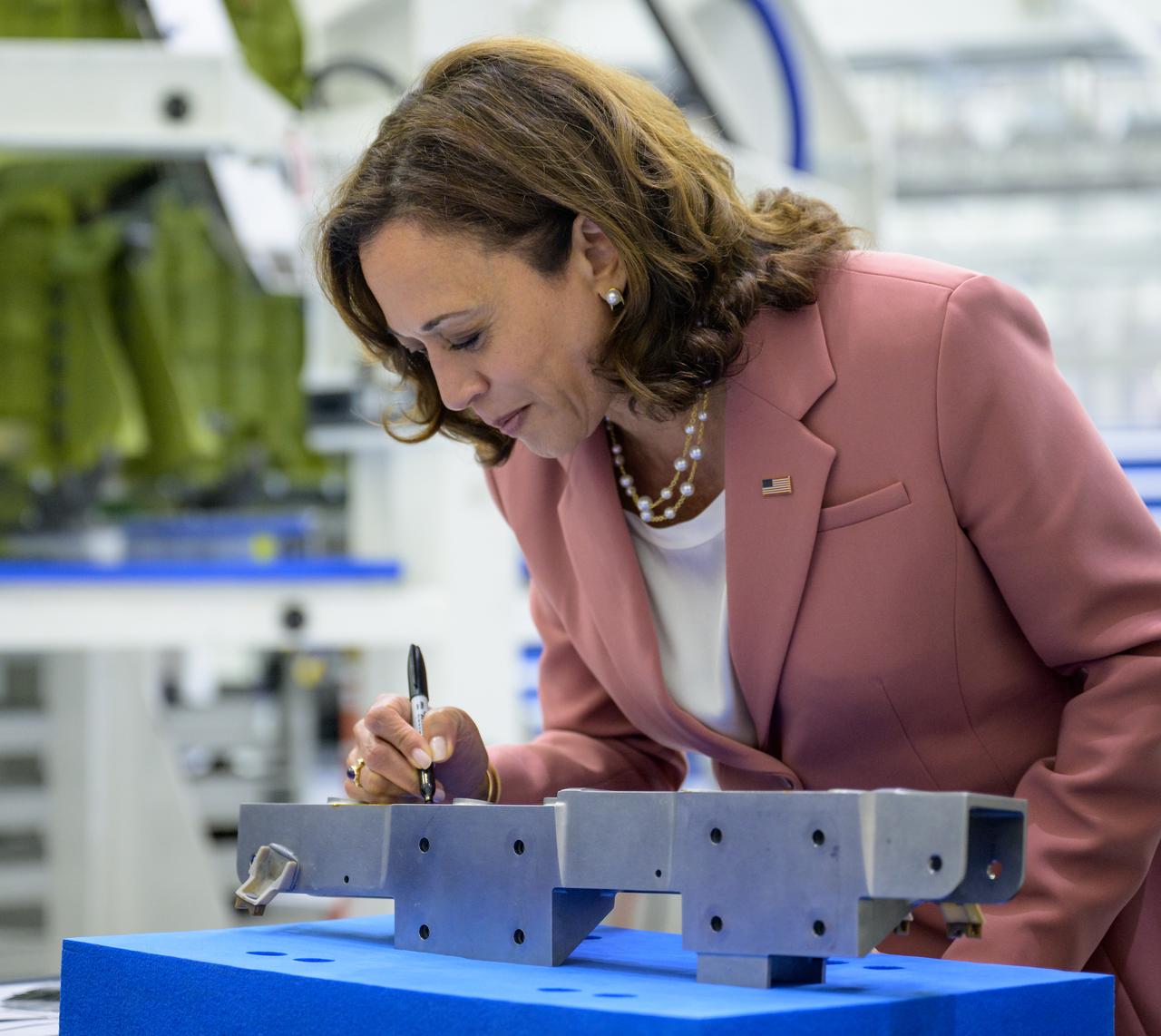 Vice President Kamala Harris signs a Orion spacecraft bracket for the Artemis III mission, Monday, Aug. 29, 2022, at the Neil  A. Armstrong Operations and Checkout Building at NASA’s Kennedy Space Center in Florida. Photo Credit: (NASA/Bill Ingalls)