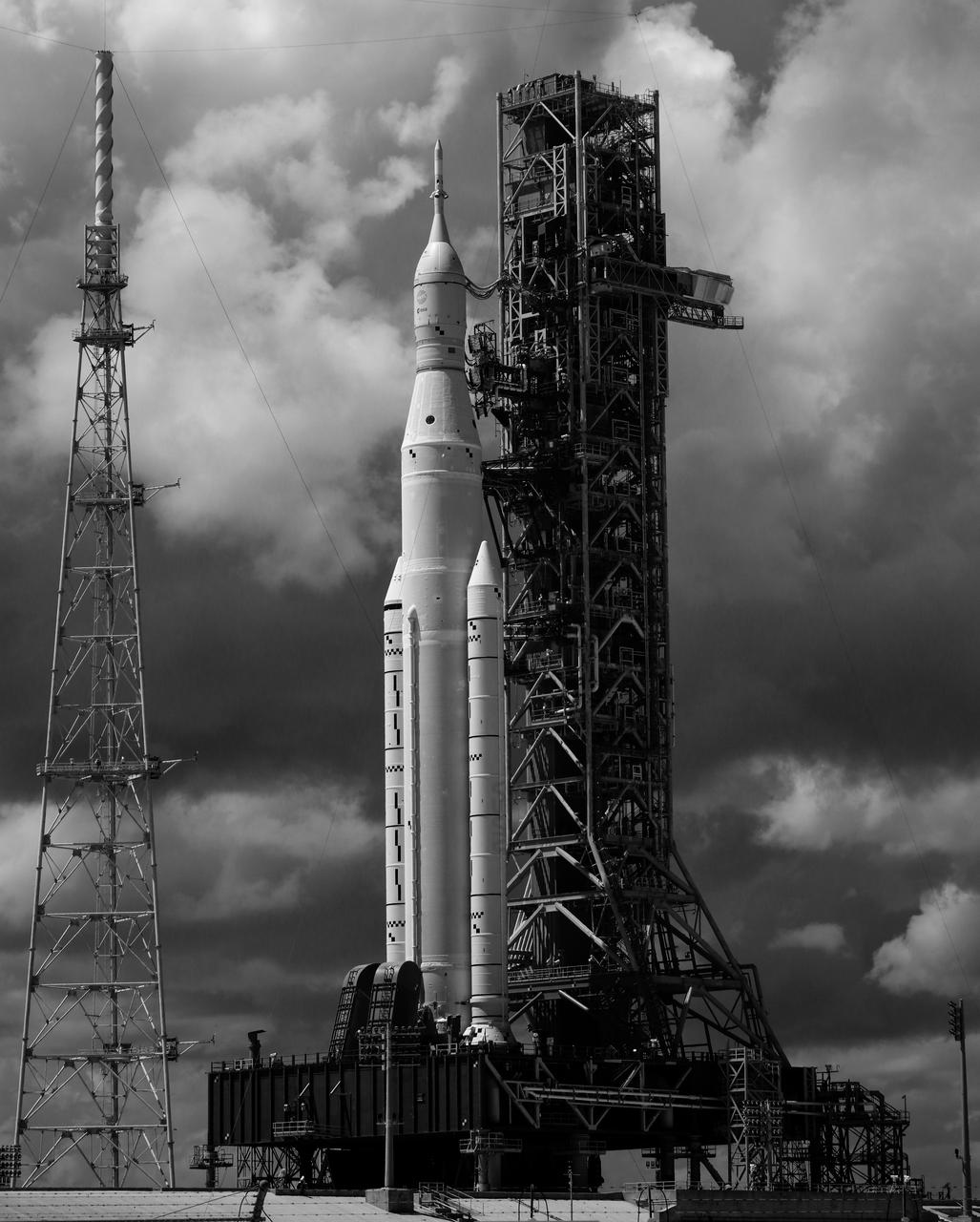 In this black and white infrared image, NASA’s Space Launch System (SLS) rocket with the Orion spacecraft aboard is seen atop the mobile launcher at Launch Pad 39B, Tuesday, Aug. 30, 2022, at NASA’s Kennedy Space Center in Florida. NASA’s Artemis I flight test is the first integrated test of the agency’s deep space exploration systems: the Orion spacecraft, SLS rocket, and supporting ground systems.  Photo Credit: (NASA/Joel Kowsky)