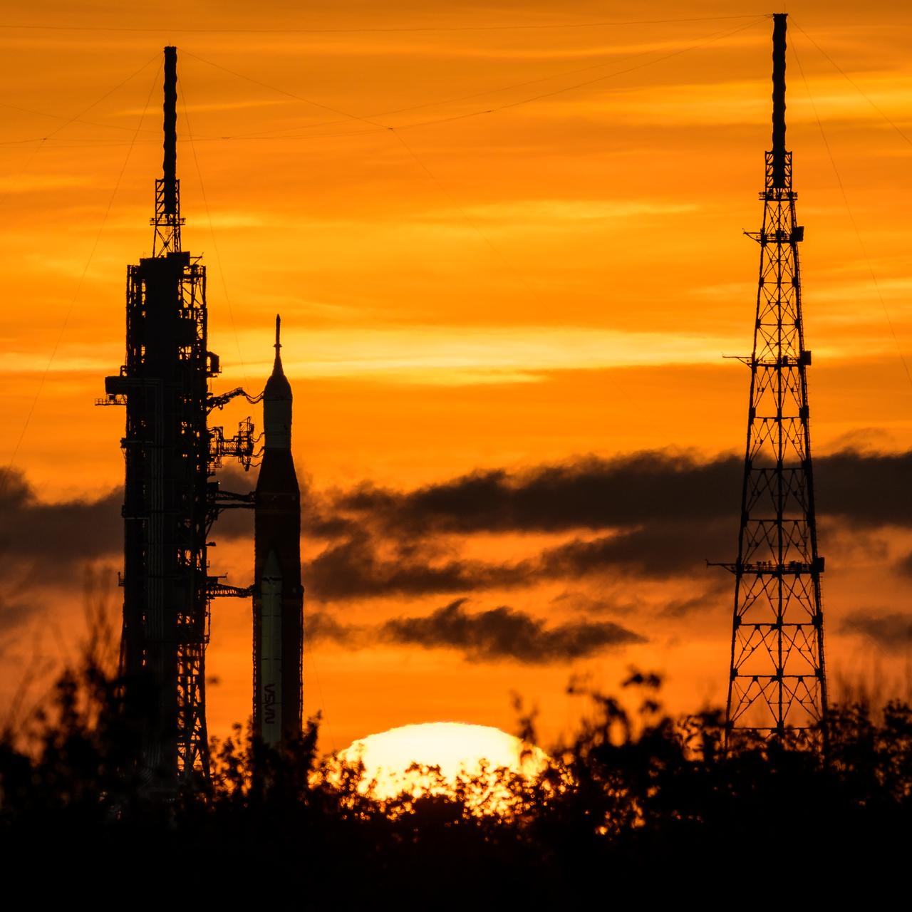 NASA’s Space Launch System (SLS) rocket with the Orion spacecraft aboard is seen during sunrise atop a mobile launcher at Launch Pad 39B as preparations for launch continue, Wednesday, Aug. 31, 2022, at NASA’s Kennedy Space Center in Florida. NASA’s Artemis I flight test is the first integrated test of the agency’s deep space exploration systems: the Orion spacecraft, SLS rocket, and supporting ground systems. Photo Credit: (NASA/Bill Ingalls)