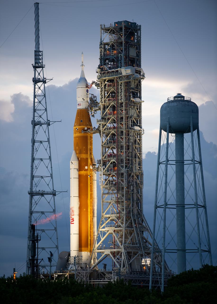 NASA’s Space Launch System (SLS) rocket with the Orion spacecraft aboard is seen at sunset atop the mobile launcher at Launch Pad 39B as preparations for launch continue, Wednesday, Aug. 31, 2022, at NASA’s Kennedy Space Center in Florida. NASA’s Artemis I flight test is the first integrated test of the agency’s deep space exploration systems: the Orion spacecraft, SLS rocket, and supporting ground systems. Launch of the uncrewed flight test is targeted for Sept. 3 at 2:17 p.m. EDT. Photo Credit: (NASA/Joel Kowsky)