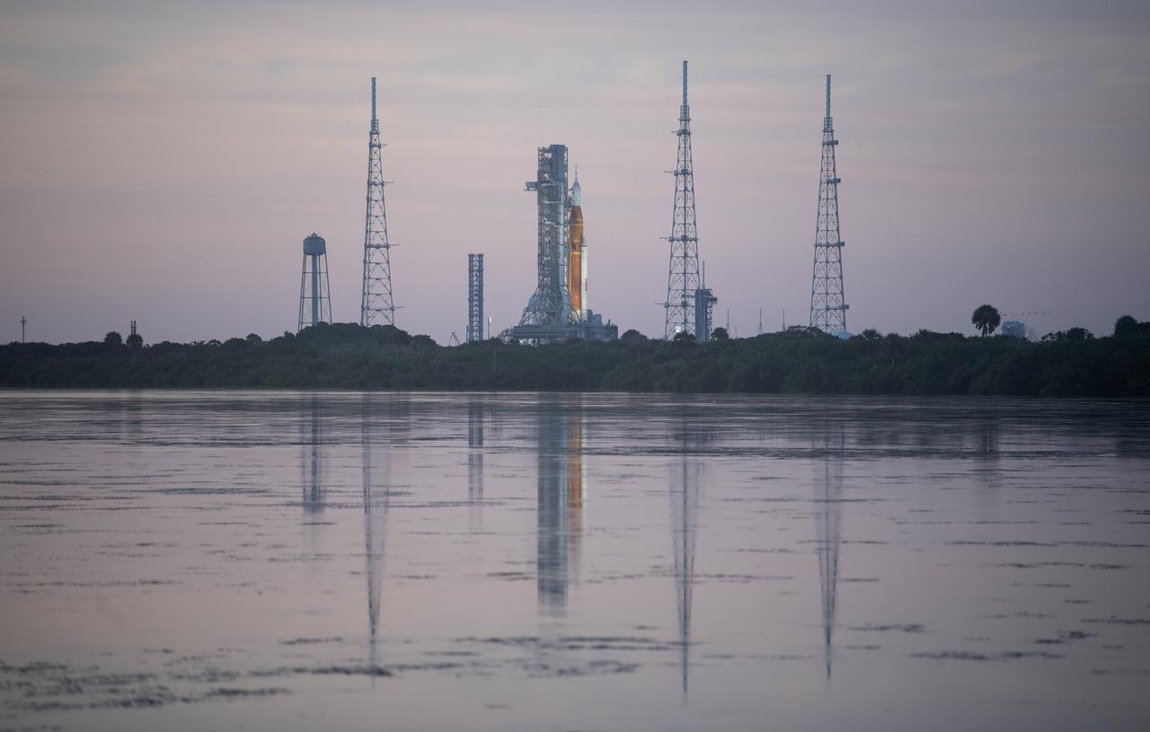 NASA’s Space Launch System (SLS) rocket with the Orion spacecraft aboard is seen at sunrise atop the mobile launcher at Launch Pad 39B as preparations for launch continue, Friday, Sept. 2, 2022, at NASA’s Kennedy Space Center in Florida. NASA’s Artemis I flight test is the first integrated test of the agency’s deep space exploration systems: the Orion spacecraft, SLS rocket, and supporting ground systems. Launch of the uncrewed flight test is targeted for Sept. 3 at 2:17 p.m. EDT.  Photo Credit: (NASA/Joel Kowsky)