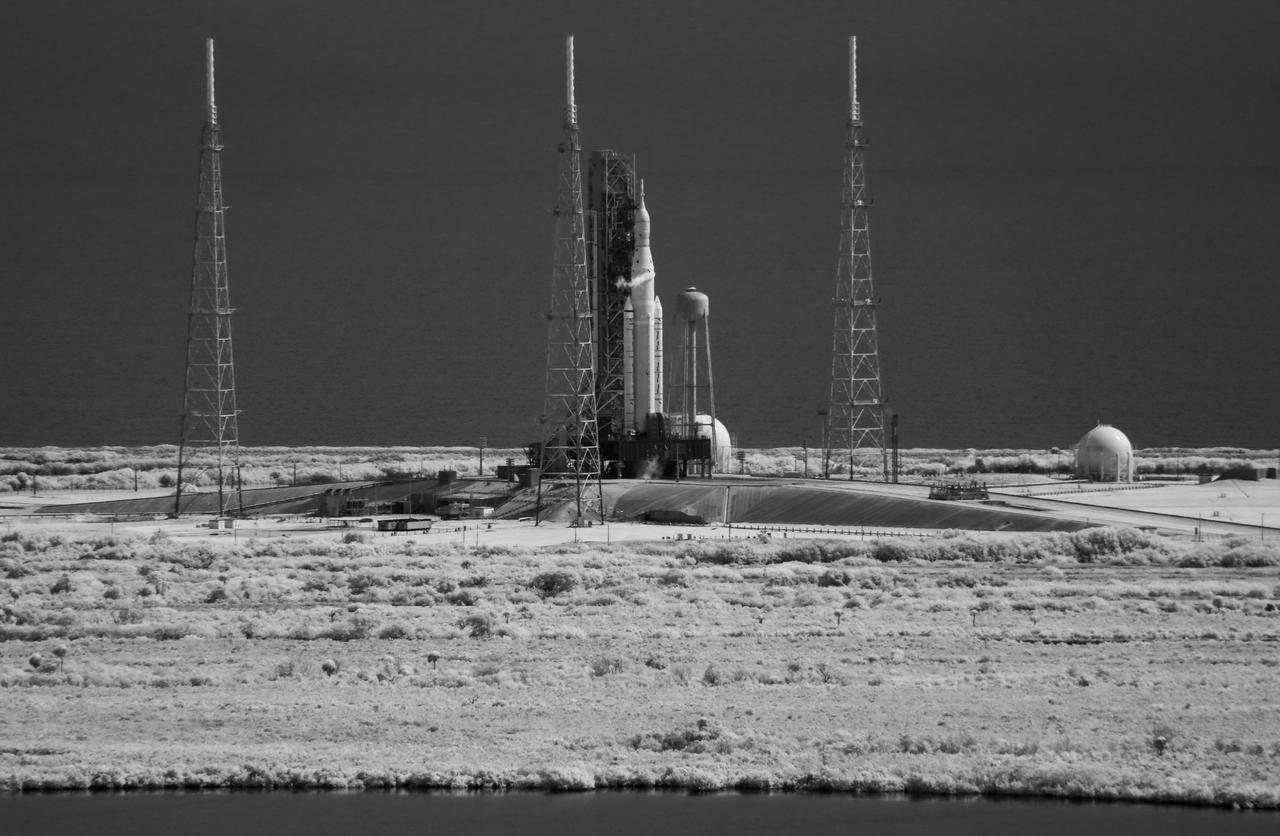 In this black and white infrared image NASA’s Space Launch System (SLS) rocket with the Orion spacecraft aboard is seen atop a mobile launcher at Launch Pad 39B as preparations for launch continue, Saturday, Sept. 3, 2022, at NASA’s Kennedy Space Center in Florida. NASA’s Artemis I flight test is the first integrated test of the agency’s deep space exploration systems: the Orion spacecraft, SLS rocket, and supporting ground systems. The launch director waived off today’s Artemis I launch attempt at approximately 11:17 a.m. EDT. Photo Credit: (NASA/Joel Kowsky)