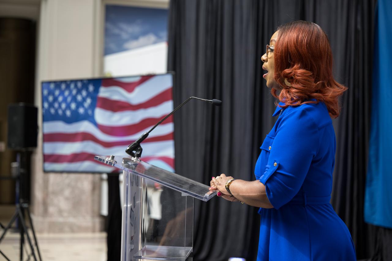 Lisa Whitehead of the United States Postal Service sings the national anthem at the first-day-of-issue event for the United States Postal Service’s new stamp celebrating NASA’s James Webb Space Telescope (JWST) on Thursday, Sept. 8, 2022, at the Smithsonian’s National Postal Museum in Washington. The stamp, which features an illustration of the observatory, honors Webb’s mission to explore the unknown in our universe – solving mysteries in our solar system, looking beyond to distant worlds around other stars, and probing the structures and origins of our universe and our place in it. Photo Credit: (NASA/Aubrey Gemignani)