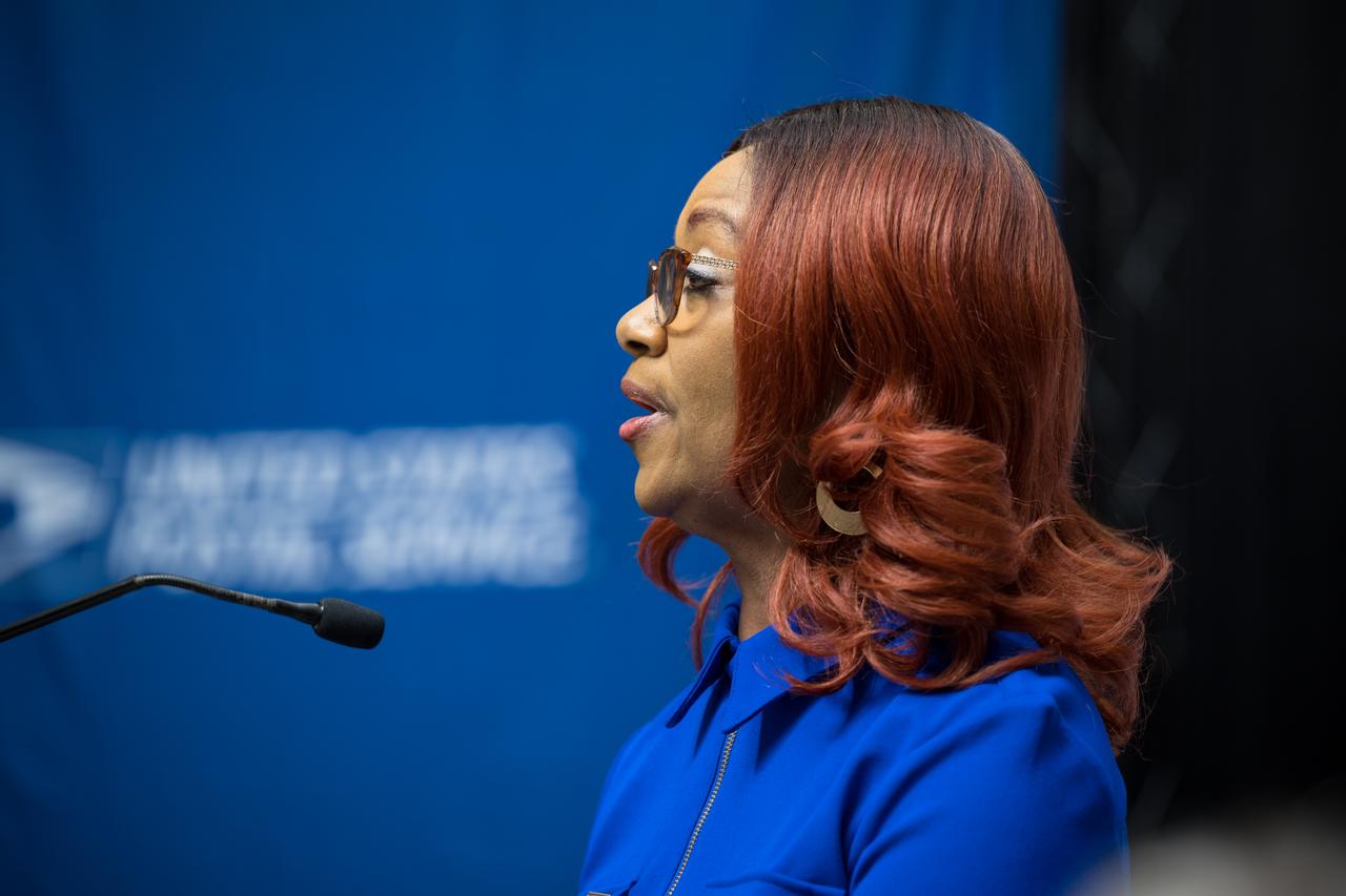 Lisa Whitehead of the United States Postal Service sings the national anthem at the first-day-of-issue event for the United States Postal Service’s new stamp celebrating NASA’s James Webb Space Telescope (JWST) on Thursday, Sept. 8, 2022, at the Smithsonian’s National Postal Museum in Washington. The stamp, which features an illustration of the observatory, honors Webb’s mission to explore the unknown in our universe – solving mysteries in our solar system, looking beyond to distant worlds around other stars, and probing the structures and origins of our universe and our place in it. Photo Credit: (NASA/Aubrey Gemignani)