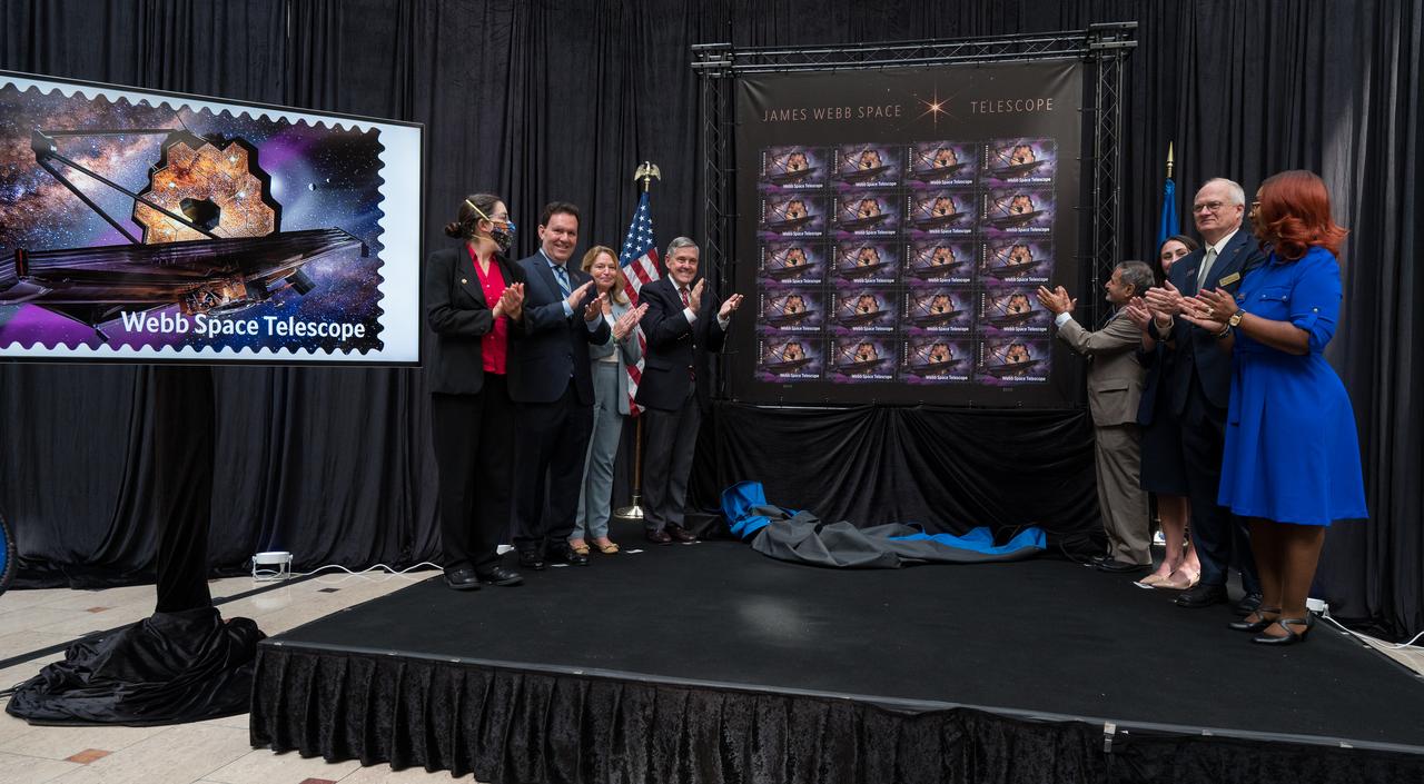 From left to right, NASA’s Goddard Space Flight Center Webb Deputy Observatory Project Scientist, Erin Smith, NASA’s Goddard Space Flight Center Webb Optical Telescope Element Manager, Lee Feinberg, Smithsonian Institution Under Secretary for Service and Research, Ellen Stofan, NASA Associate Administrator and former astronaut Bob Cabana, United States Postal Service Vice Chairman, Board of Governors, Anton Hajjar, NASA public affairs specialist Alice Fisher, National Postal Museum Deputy Director, Toby Mensforth, and Lisa Whitehead, USPS, applaud after unveiling the United States Postal Service’s new stamp celebrating NASA’s James Webb Space Telescope (JWST) at the first-day-of-issue event on Thursday, Sept. 8, 2022, at the Smithsonian’s National Postal Museum in Washington. The stamp, which features an illustration of the observatory, honors Webb’s mission to explore the unknown in our universe – solving mysteries in our solar system, looking beyond to distant worlds around other stars, and probing the structures and origins of our universe and our place in it. Photo Credit: (NASA/Aubrey Gemignani)