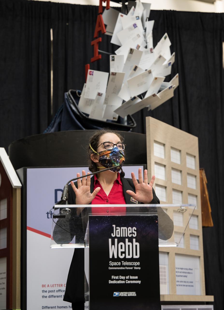 NASA’s Goddard Space Flight Center Webb Deputy Observatory Project Scientist, Erin Smith, provides remarks at the first-day-of-issue event for the United States Postal Service’s new stamp celebrating NASA’s James Webb Space Telescope (JWST) on Thursday, Sept. 8, 2022, at the Smithsonian’s National Postal Museum in Washington. The stamp, which features an illustration of the observatory, honors Webb’s mission to explore the unknown in our universe – solving mysteries in our solar system, looking beyond to distant worlds around other stars, and probing the structures and origins of our universe and our place in it. Photo Credit: (NASA/Aubrey Gemignani)