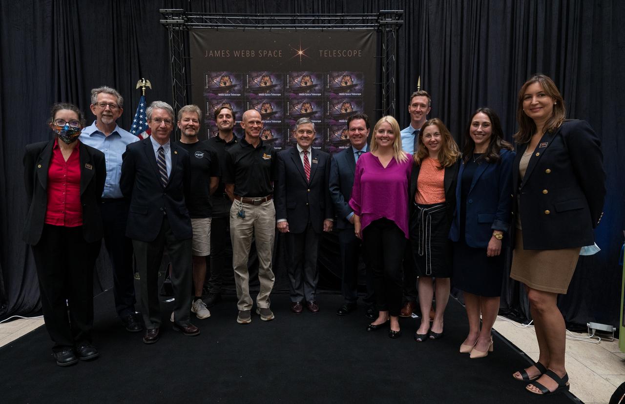 James Webb Space Telescope team members pose for a photo at the first-day-of-issue event for the United States Postal Service’s new stamp celebrating NASA’s James Webb Space Telescope (JWST) on Thursday, Sept. 8, 2022, at the Smithsonian’s National Postal Museum in Washington. The stamp, which features an illustration of the observatory, honors Webb’s mission to explore the unknown in our universe – solving mysteries in our solar system, looking beyond to distant worlds around other stars, and probing the structures and origins of our universe and our place in it. Photo Credit: (NASA/Aubrey Gemignani)