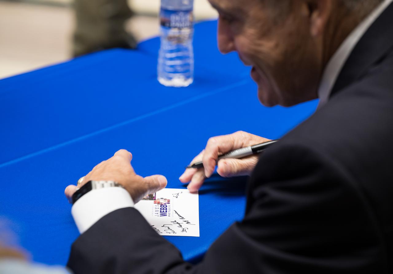 NASA Associate Administrator and former astronaut Bob Cabana, autographs a piece of mail with the United States Postal Service’s new stamp celebrating NASA’s James Webb Space Telescope (JWST) on it, at the first-day-of-issue event, Thursday, Sept. 8, 2022, at the Smithsonian’s National Postal Museum in Washington. The stamp, which features an illustration of the observatory, honors Webb’s mission to explore the unknown in our universe – solving mysteries in our solar system, looking beyond to distant worlds around other stars, and probing the structures and origins of our universe and our place in it. Photo Credit: (NASA/Aubrey Gemignani)