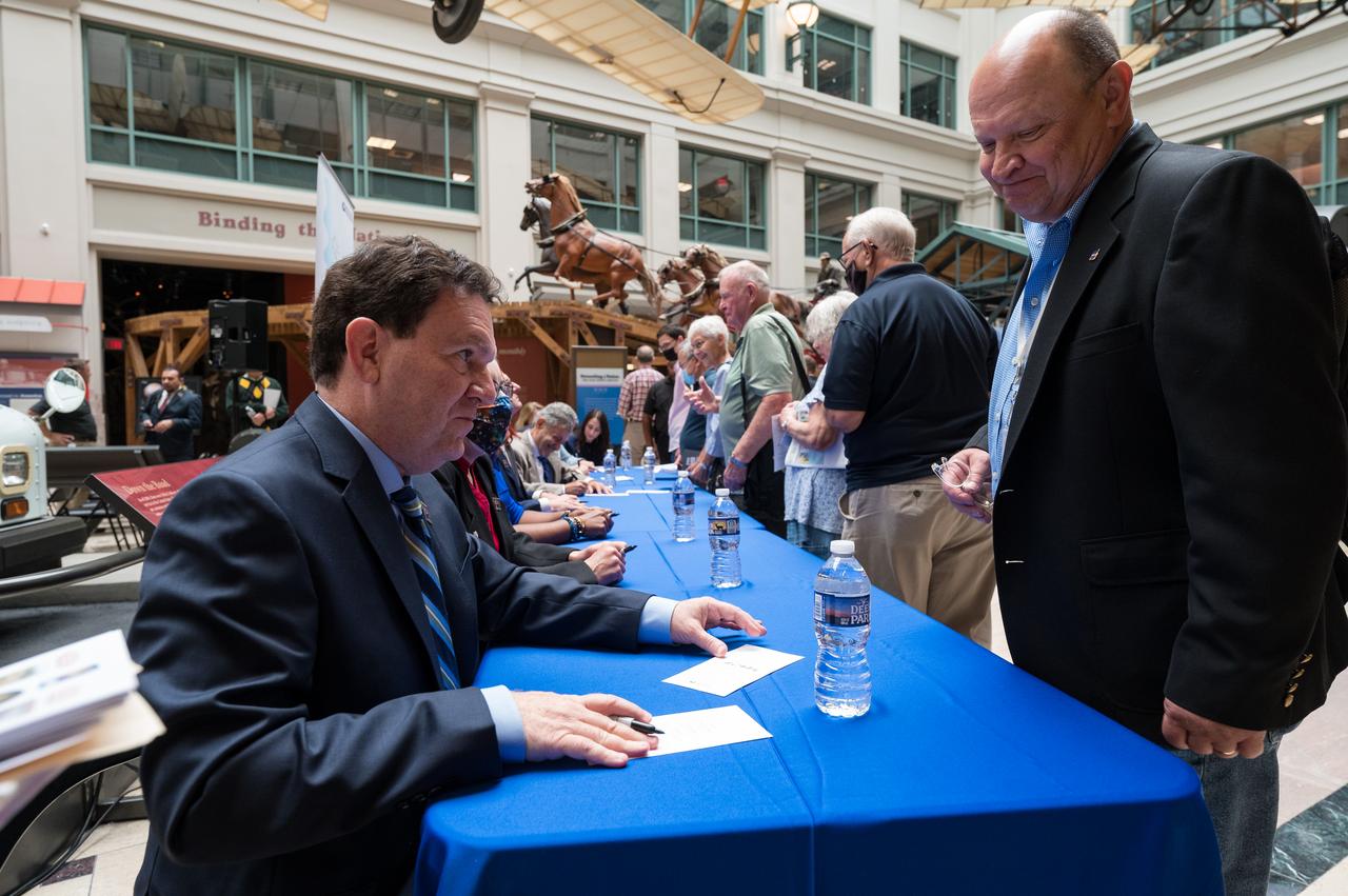 NASA’s Goddard Space Flight Center Webb Optical Telescope Element Manager, Lee Feinberg, autographs a piece of mail with the United States Postal Service’s new stamp celebrating NASA’s James Webb Space Telescope (JWST) on it, at the first-day-of-issue event, Thursday, Sept. 8, 2022, at the Smithsonian’s National Postal Museum in Washington. The stamp, which features an illustration of the observatory, honors Webb’s mission to explore the unknown in our universe – solving mysteries in our solar system, looking beyond to distant worlds around other stars, and probing the structures and origins of our universe and our place in it. Photo Credit: (NASA/Aubrey Gemignani)