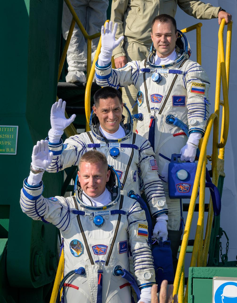 Expedition 68 crew members Dmitri Petelin of Roscosmos, top, Frank Rubio of NASA, and Sergey Prokopyev of Roscosmos, bottom, wave farewell prior to boarding the Soyuz MS-22 spacecraft for launch, Wednesday, Sept. 21, 2022, at the Baikonur Cosmodrome in Kazakhstan. Rubio, Prokopyev and Petelin, will launch onboard the Soyuz rocket from the Baikonur Cosmodrome for a mission on the International Space Station. Photo Credit: (NASA/Bill Ingalls)