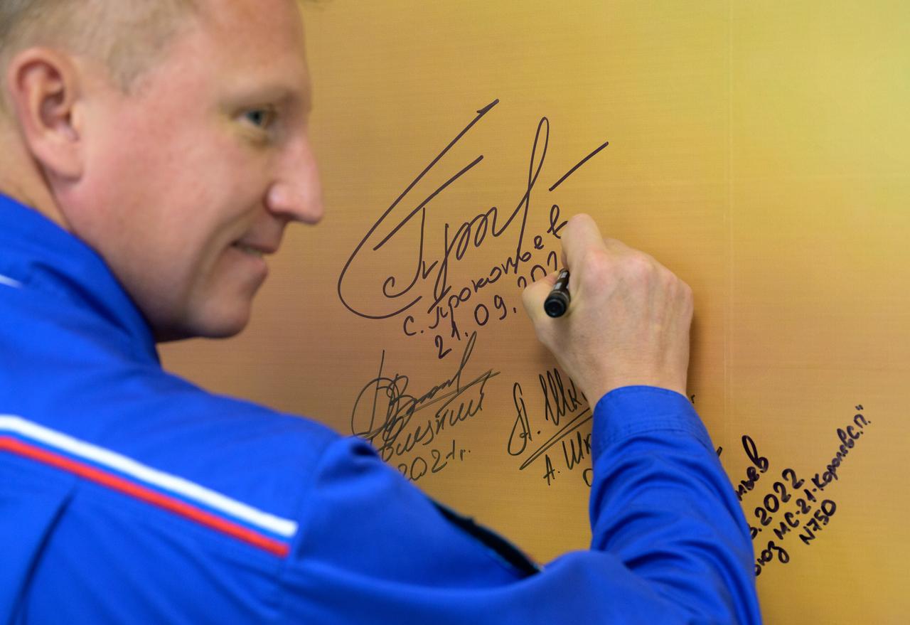 Expedition 68 cosmonaut Sergey Prokopyev of Roscosmos signs a photo inside the Cosmonaut Hotel prior to departing for building 254 in order to suitup for launch on a Soyuz rocket with fellow crewmates Dmitri Petelin of Roscosmos and Frank Rubio of NASA, Wednesday, Sept. 21, 2022, in Baikonur, Kazakhstan. Rubio, Prokopyev and Petelin launched on their Soyuz MS-22 spacecraft later in the day from the Baikonur Cosmodrome for a mission on the International Space Station. Photo Credit: (NASA/Bill Ingalls)