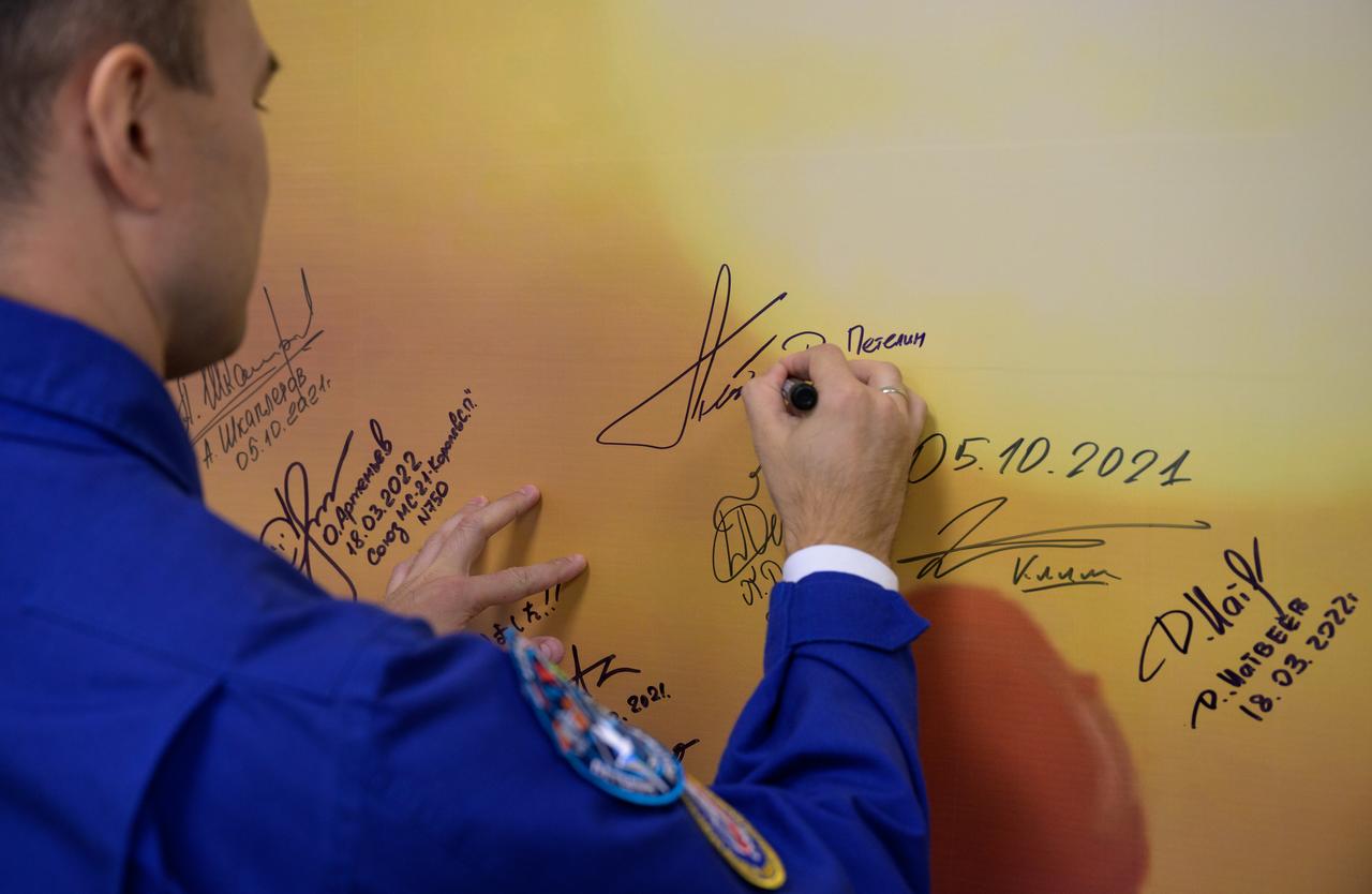 Expedition 68 cosmonaut Dmitri Petelinof Roscosmos signs a photo inside the Cosmonaut Hotel prior to departing for building 254 in order to suitup for launch on a Soyuz rocket with fellow crewmates Sergey Prokopyev of Roscosmos and Frank Rubio of NASA, Wednesday, Sept. 21, 2022, in Baikonur, Kazakhstan. Rubio, Prokopyev and Petelin launched on their Soyuz MS-22 spacecraft later in the day from the Baikonur Cosmodrome for a mission on the International Space Station. Photo Credit: (NASA/Bill Ingalls)