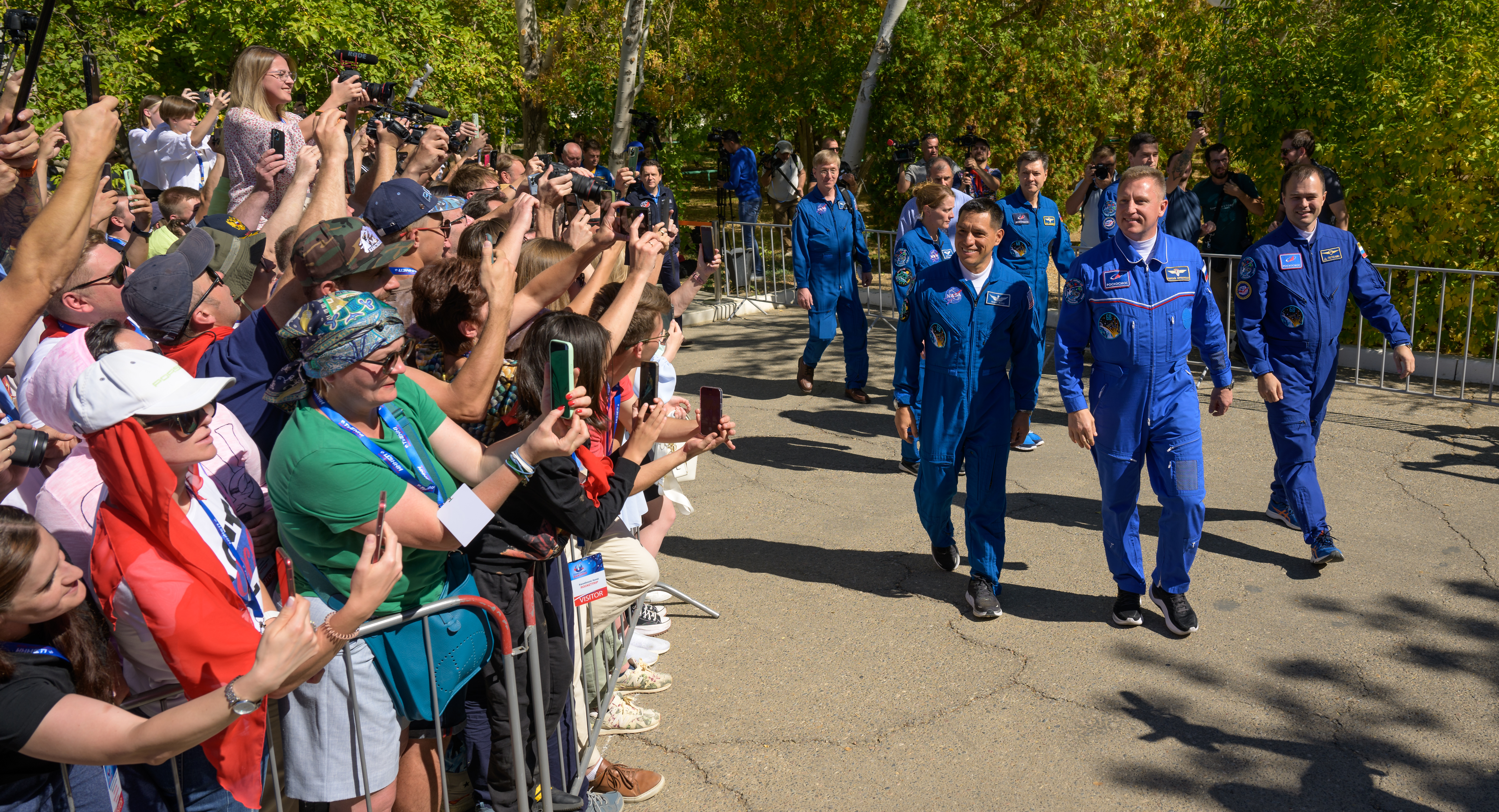 Expedition 68 astronaut Frank Rubio of NASA, left, and cosmonauts Sergey Prokopyev and Dmitri Petelin of Roscosmos, right, wave as they depart the Cosmonaut Hotel to suit-up for their Soyuz launch to the International Space Station, Wednesday, Sept. 21, 2022, in Baikonur, Kazakhstan. Rubio, Prokopyev and Petelin launched on their Soyuz MS-22 spacecraft later in the day from the Baikonur Cosmodrome for a mission on the International Space Station. Photo Credit: (NASA/Bill Ingalls)