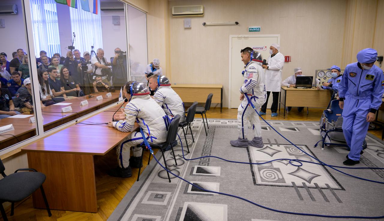 Expedition 68 astronaut Frank Rubio of NASA joins fellow crewmates, Sergey Prokopyev and Dmitri Petelin of Roscosmos in talking to family and friends after having their Russian Sokol suits pressure checked ahead of their Soyuz MS-22 spacecraft launch, Wednesday, Sept. 21, 2022, in Baikonur, Kazakhstan. Rubio, Prokopyev and Petelin launched onboard the Soyuz rocket from the Baikonur Cosmodrome for a mission on the International Space Station. Photo Credit: (NASA/Bill Ingalls)